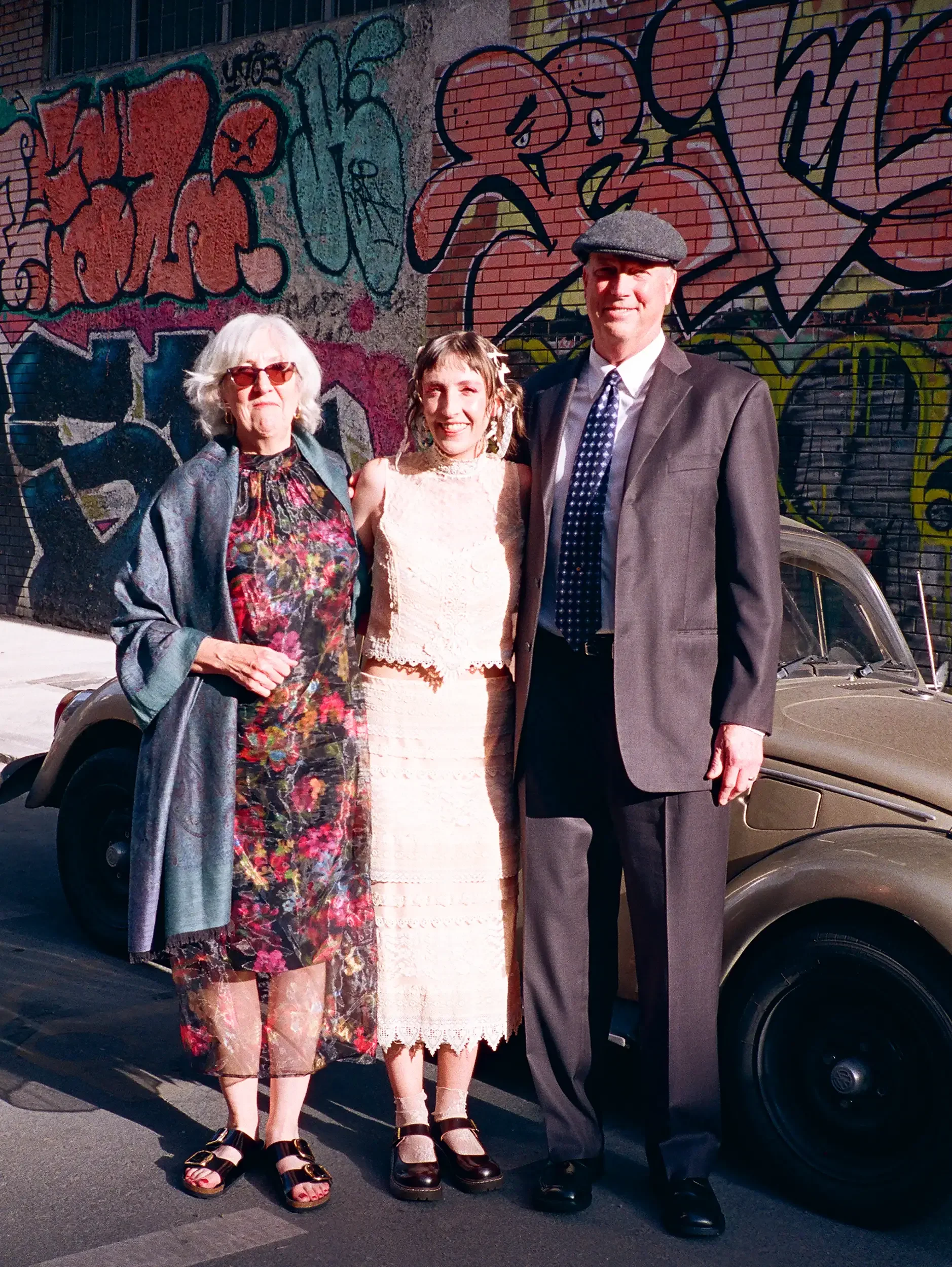 Hannah with her parents, wearing what her mom wore first — refashioned to fit her own day. Photo: Rou Rodriguez.