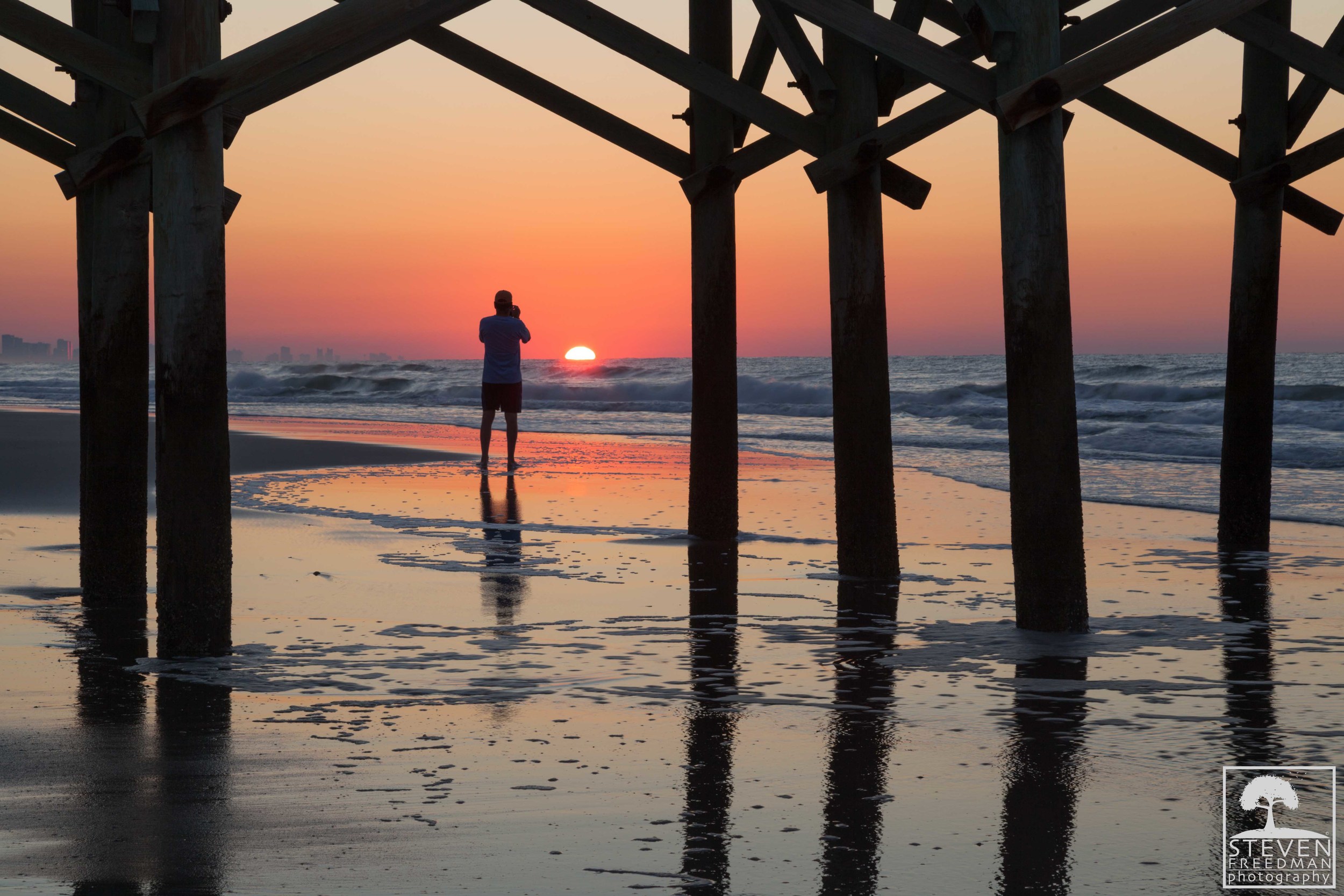 This guy walked out in front of me when I was shooting this sunrise. At first I was not happy but now I think his silhouette and reflection adds a lot to the image. 