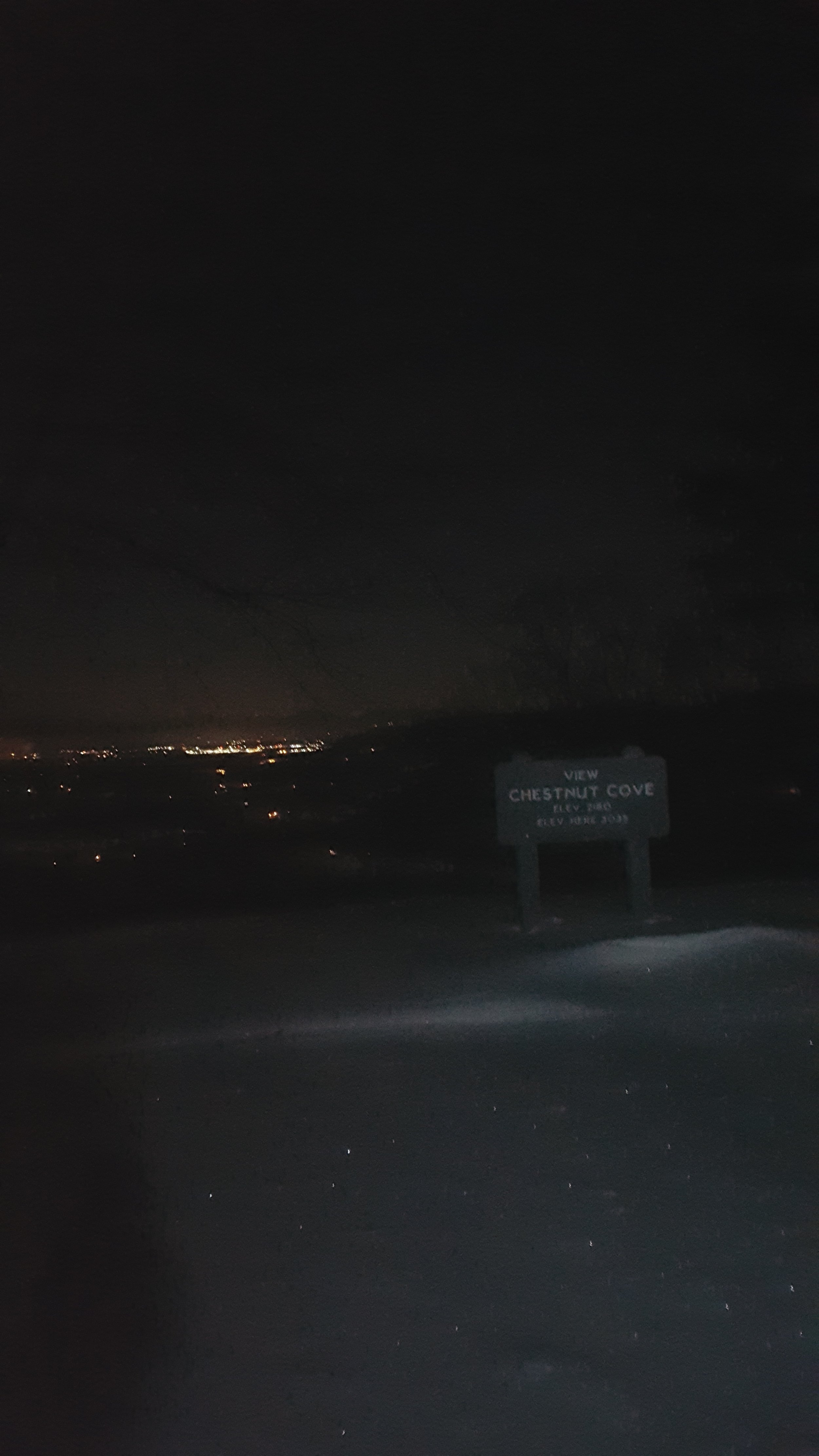 A cell phone shot from the Chestnut Cove Overlook with Fletcher and Hendersonville lit up in the background. 