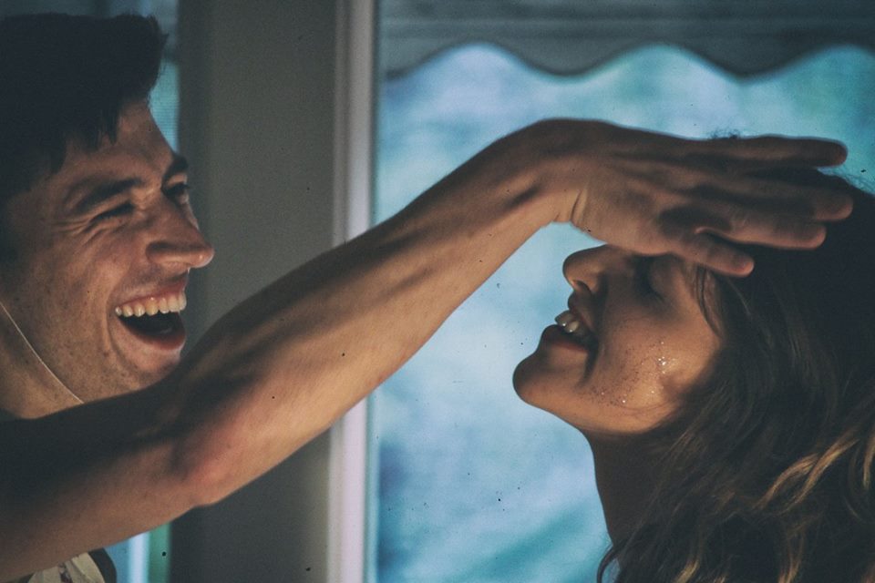 Adam spreads glitter on dancer Anna Zekan's face before a show in Astoria. Credit Joe Desimone.
