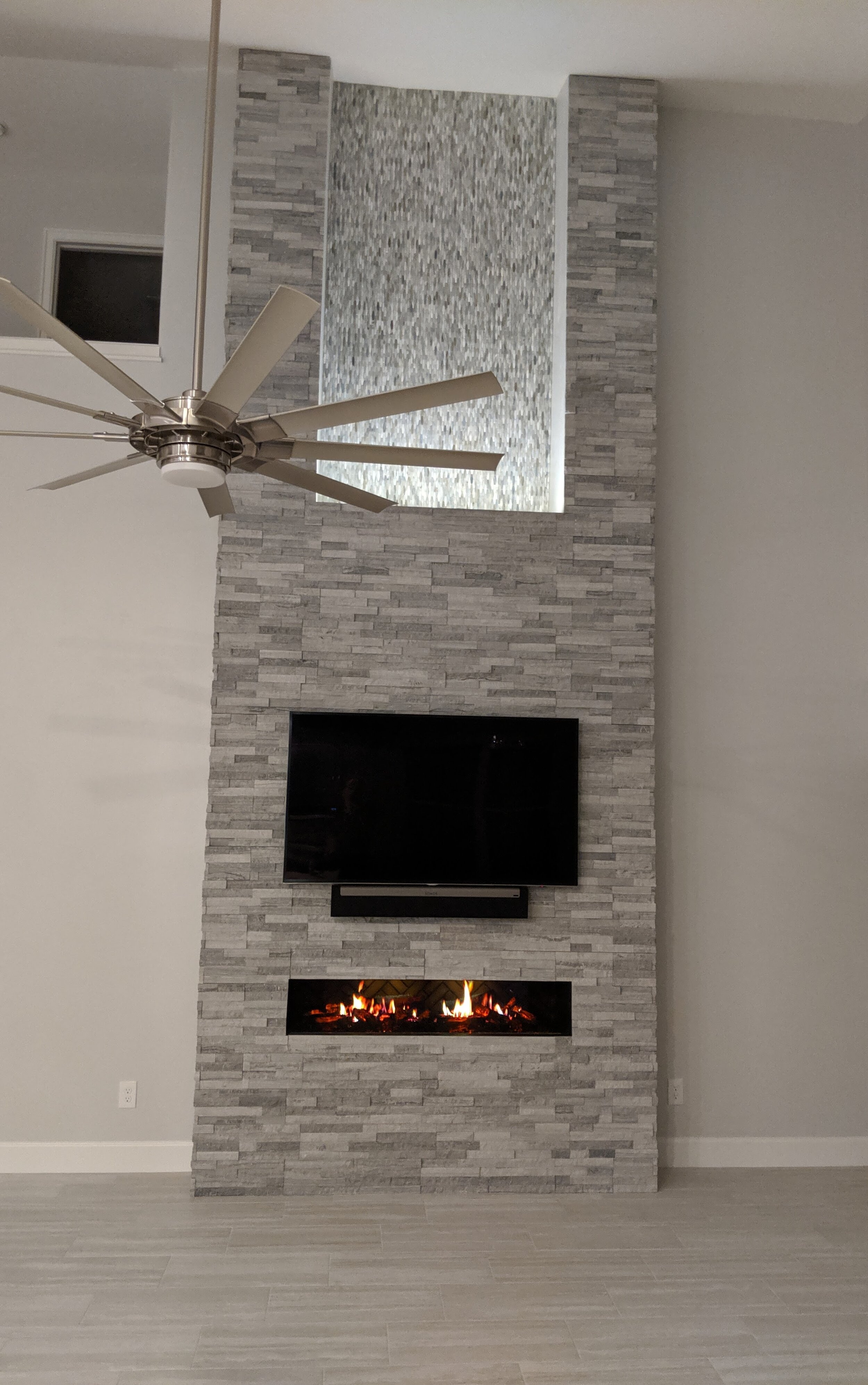 TV installed over fire place with lighting.jpg