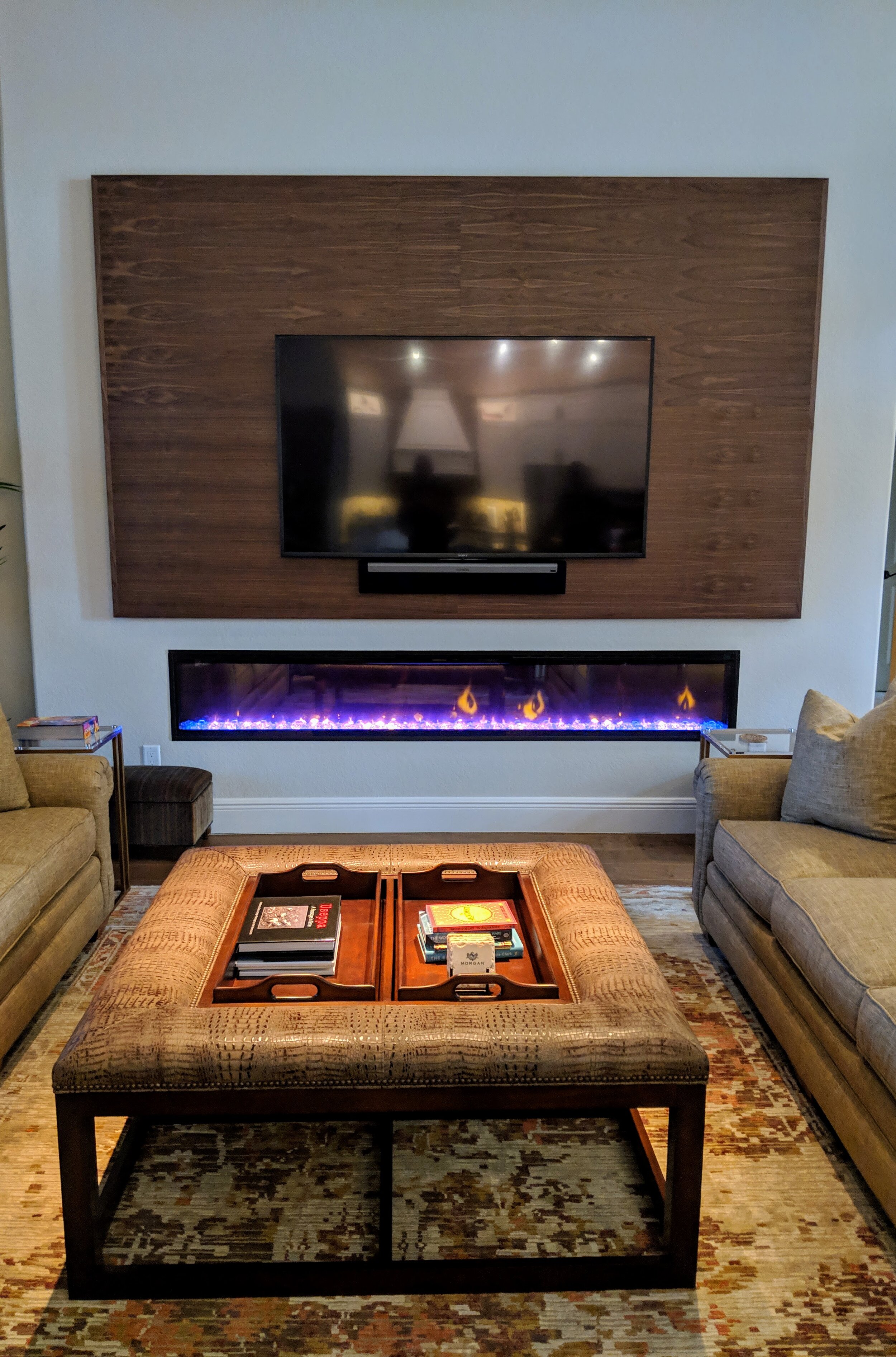 TV installed over fireplace on wooden wall.jpg