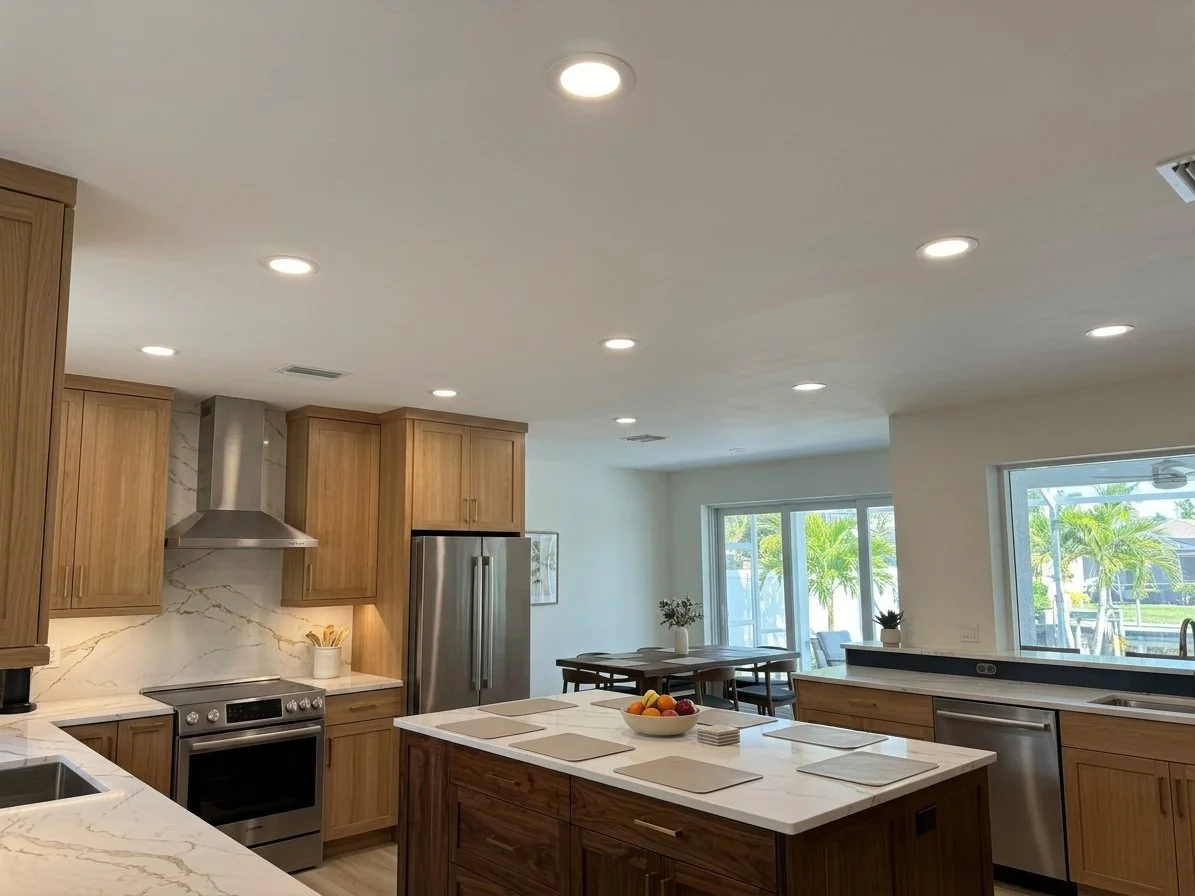 Modern Southwest Florida kitchen featuring ultra-thin LED wafer lights installed flush with drywall ceiling by 1HTI Master Electrician