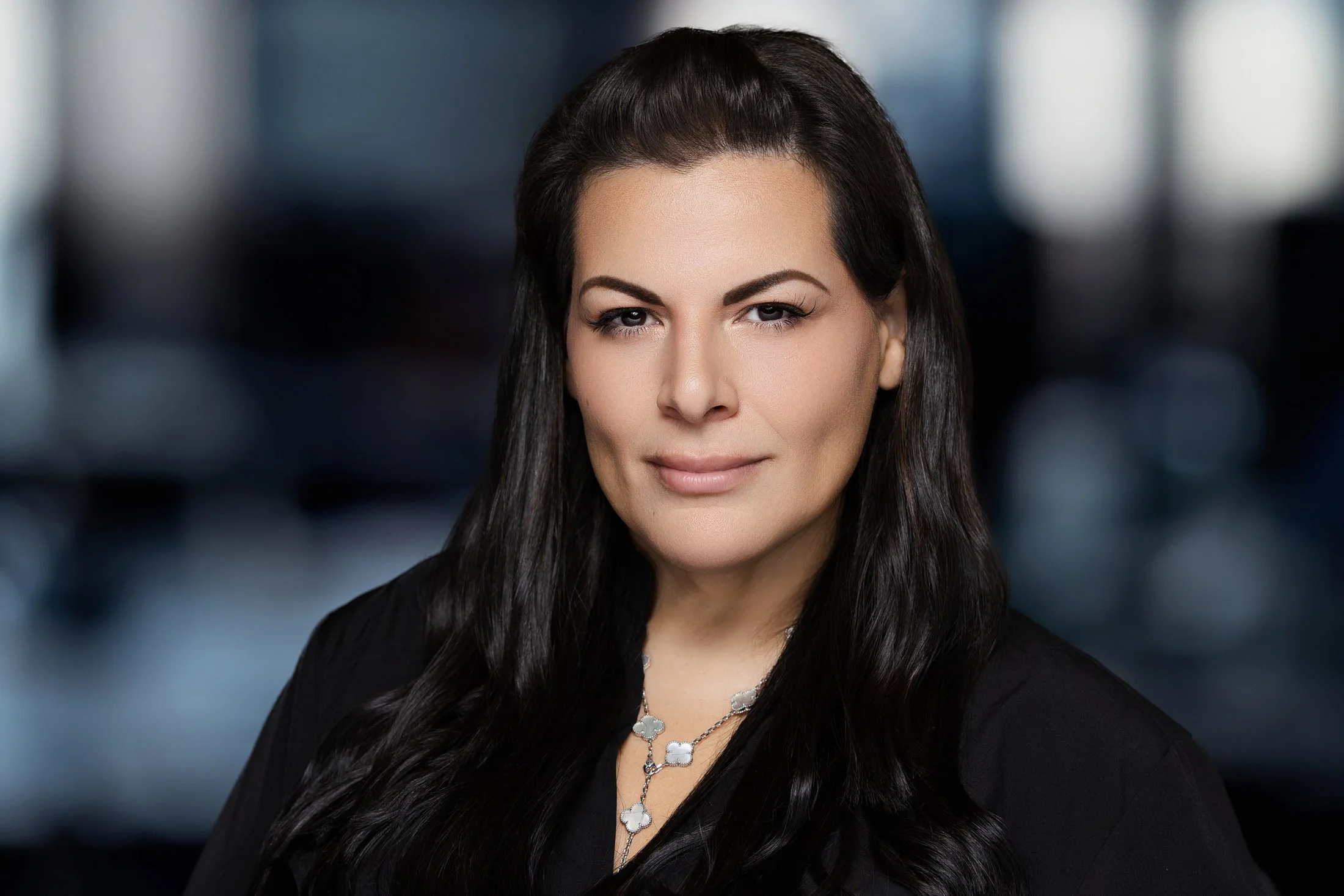 Relaxed and engaging personal branding headshot with a mix of studio and natural light.