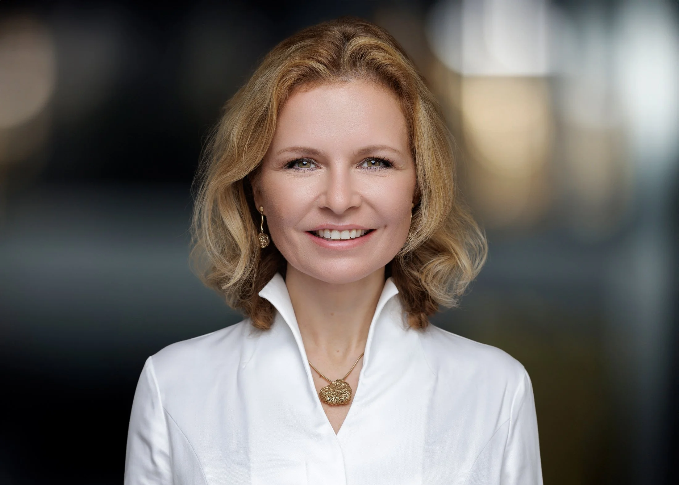 Relaxed and engaging personal branding headshot with a mix of studio and natural light.