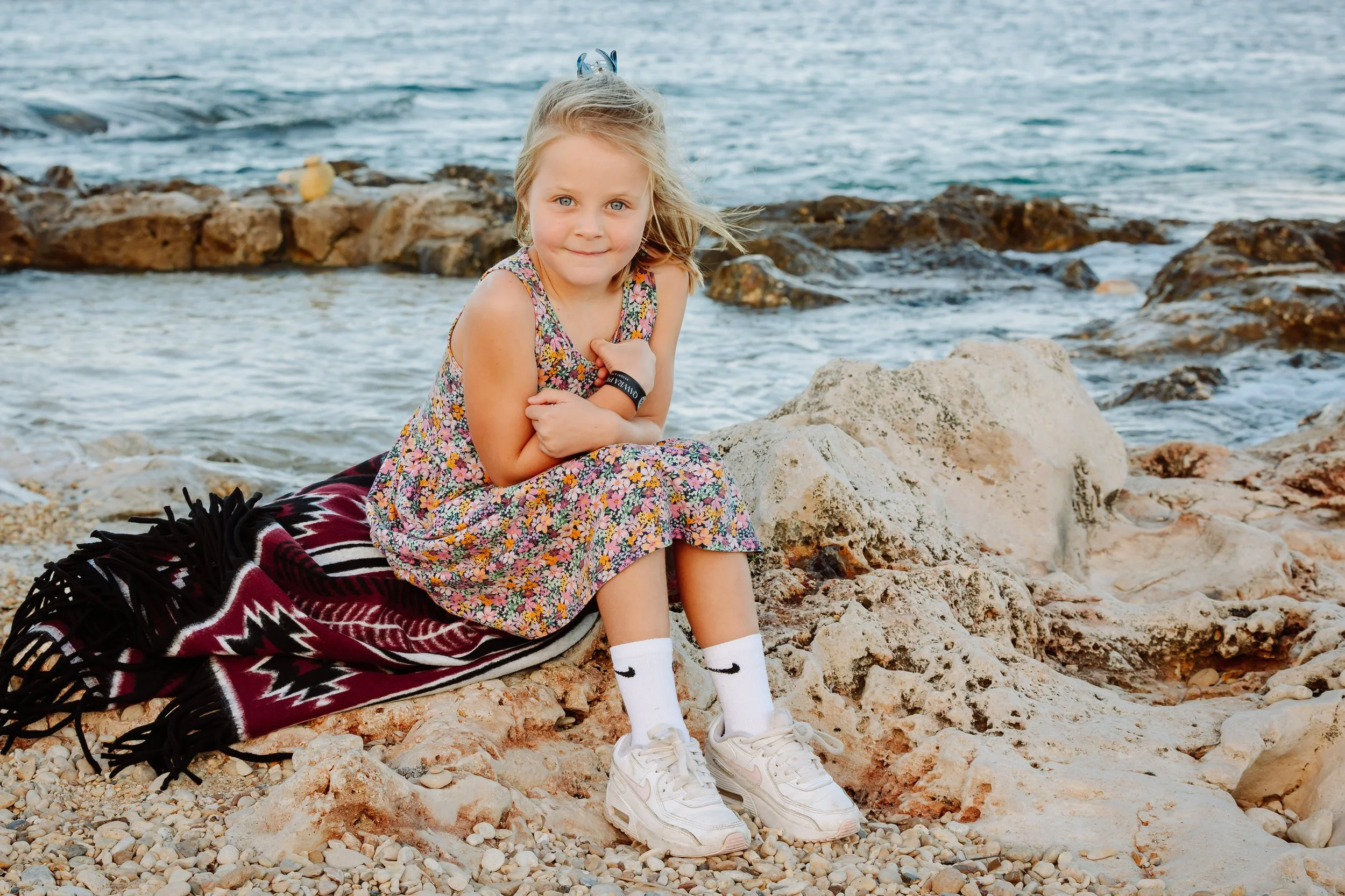 Girl sitting on the rocks of Malta