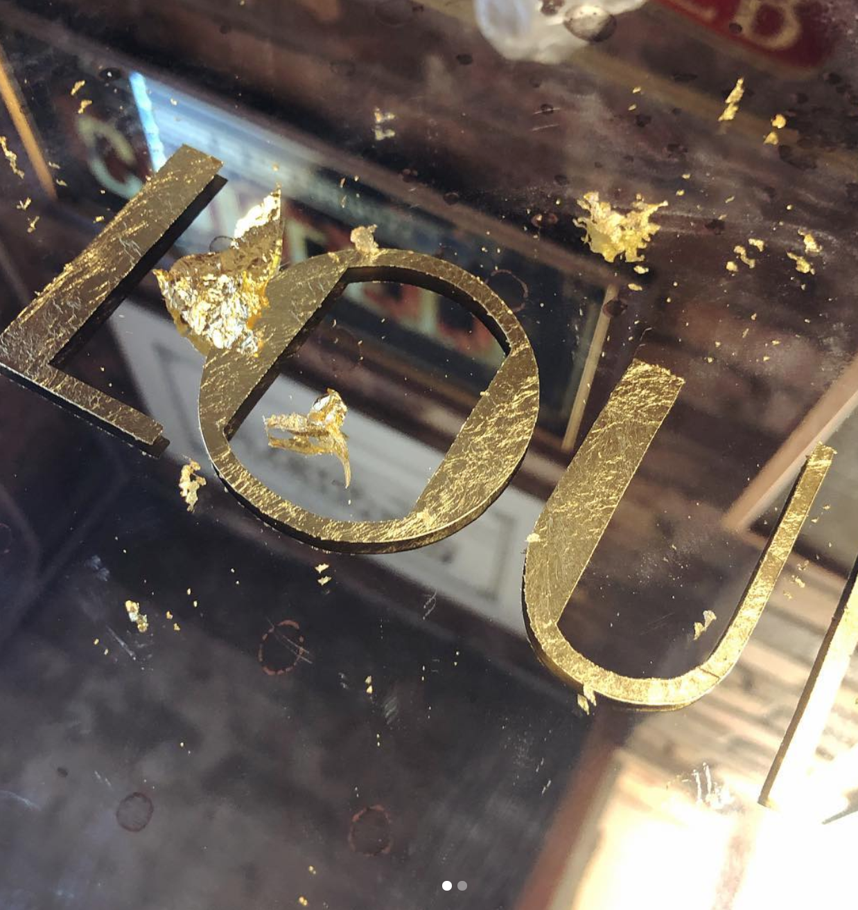  Mirror signage before the removal of the excess gold leaf 
