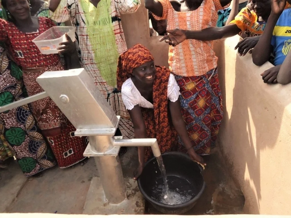 A woman near Kelo, Chad draws clean water from a Living Water Project well for the first time - January, 2017