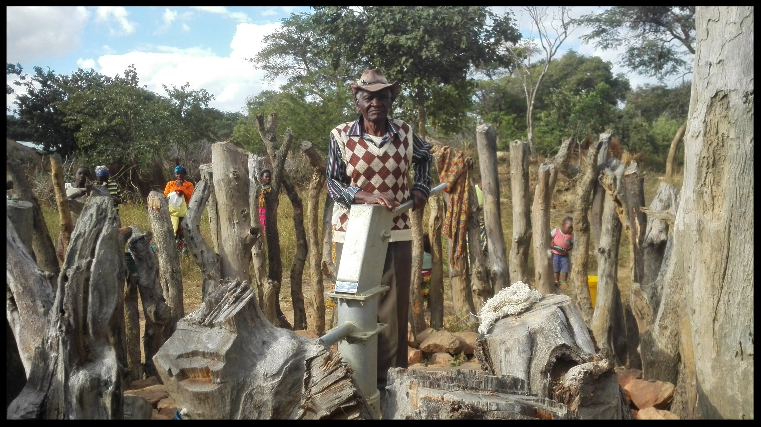 The wells built in Zambia have a hand pump (pictured). The village work together to build a fence around the well to protect it from wildlife and livestock. The village forms a committee to take responsibility for well maintenance. The man pictured here is the Elder of the Sibalwa well committee.