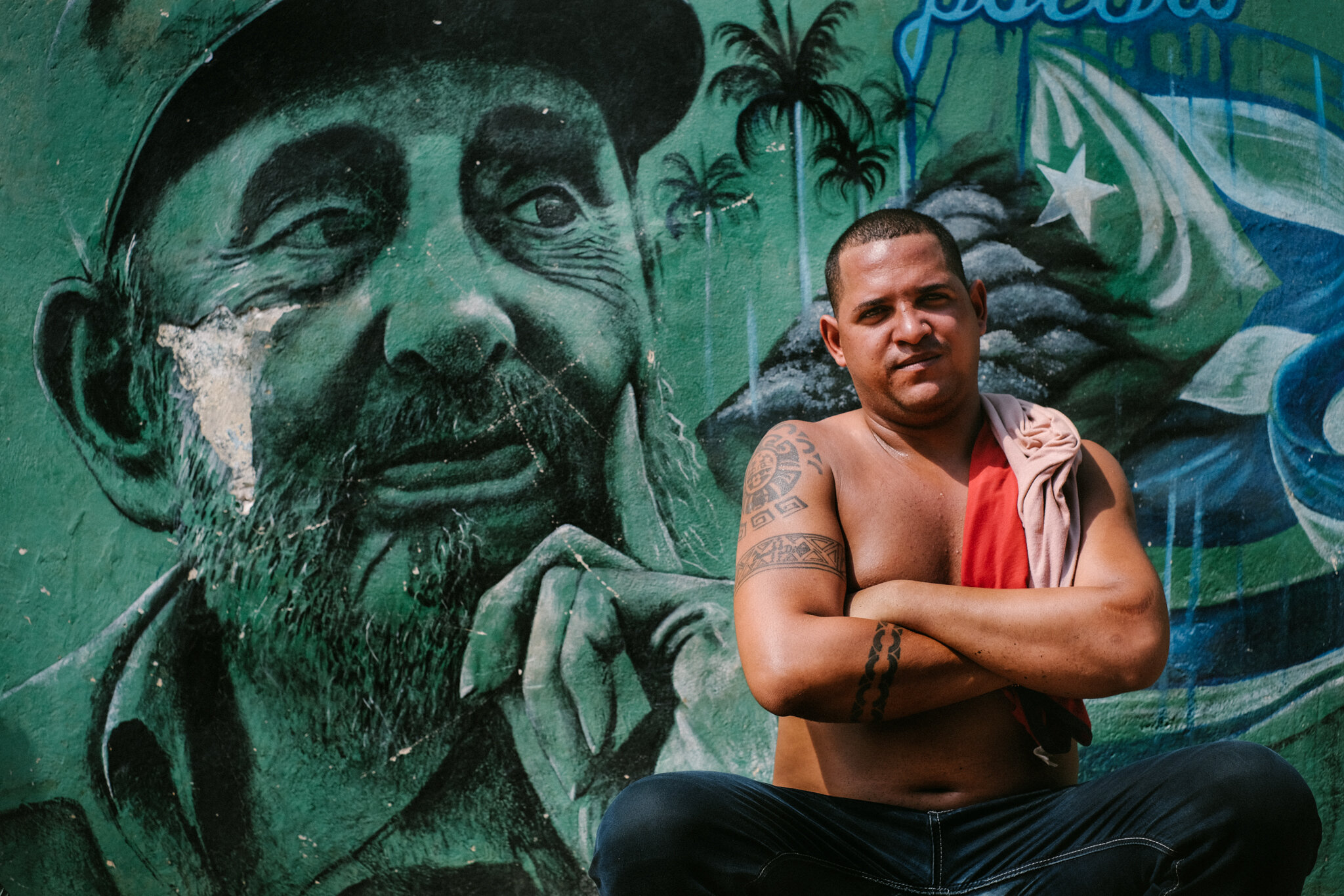  A Cuban man posing in front of a mural of Fidel Castro in Buenavista, Havana © James Clifford Kent  