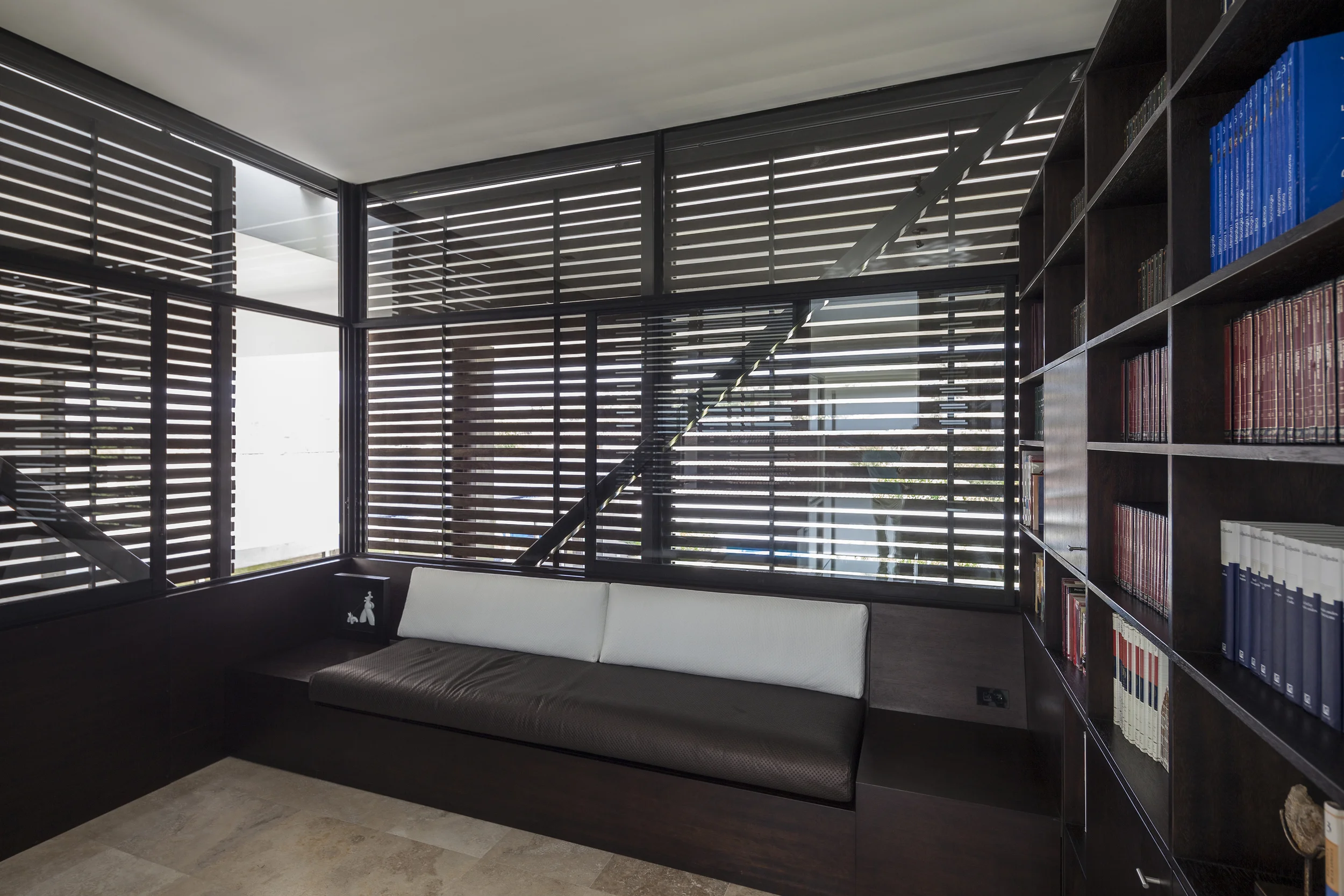 Casa L6, interior del volumen colgante, biblioteca privada con celosías de madera. Diseñado por Endara Arquitectos