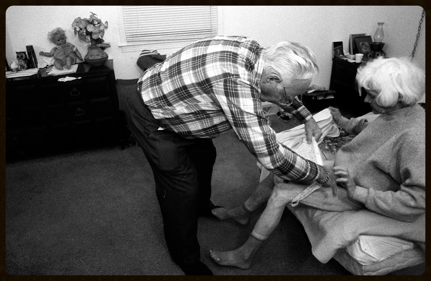 Earl gets Norma ready for the day by helping her get dressed.