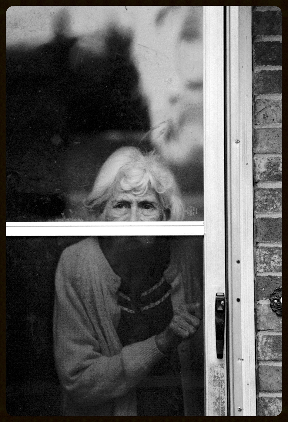 Norma watches from the front door as Earl pulls away from the house.