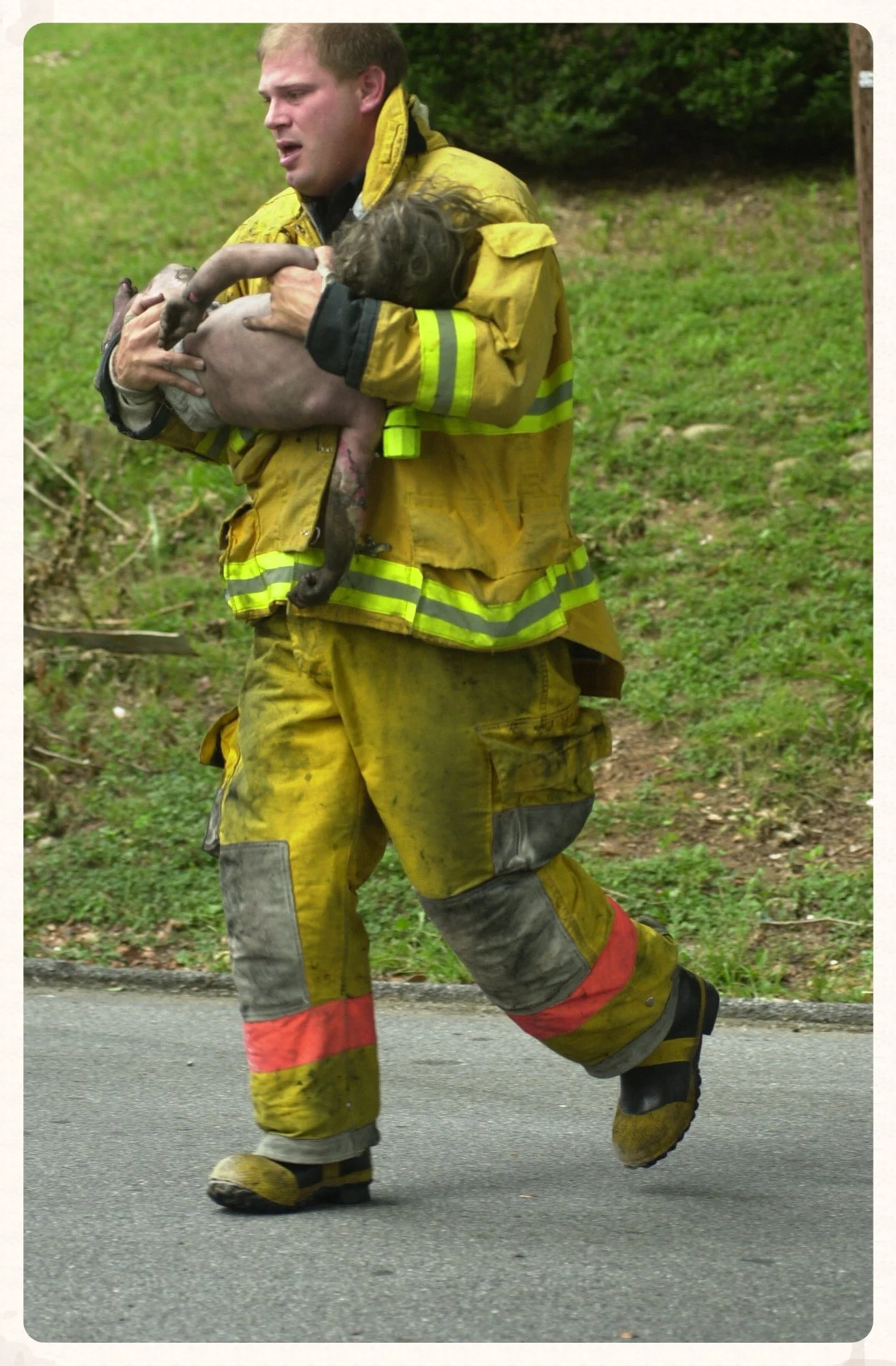  A Chattanooga firefighter carries a four-year-old from a house fire to a waiting ambulance. The boy was pronounced dead during his airlift to another hospital. 