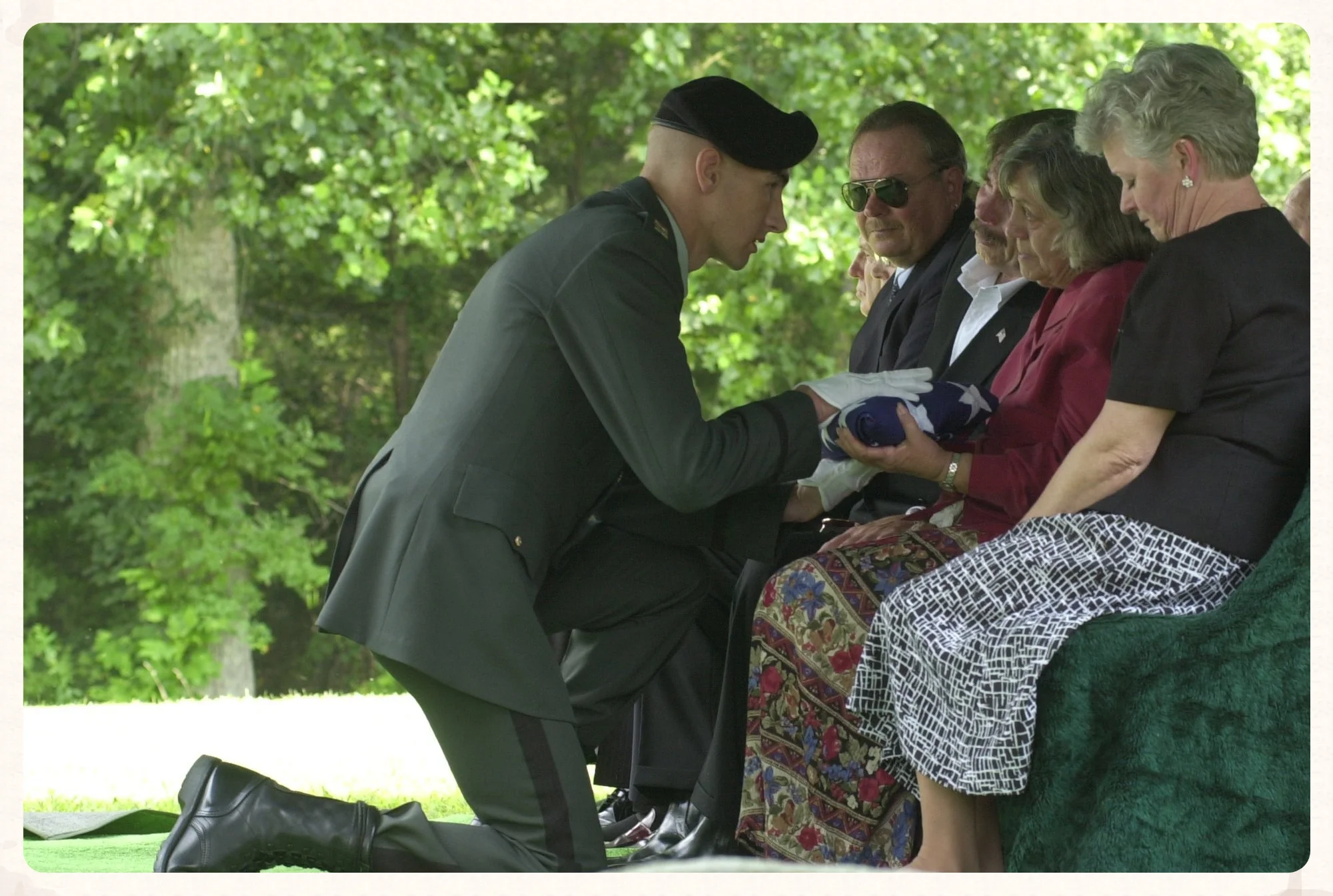  Capt. Steve Eastman of the 101st Airborne Division from Ft. Campbell, Ky. presents Virginia Stone, daughter of Early Hoodenpyle, with the American flag that had draped Mr. Hoodenpyle's casket. Early Hoodenpyle, who was buried with full military hono