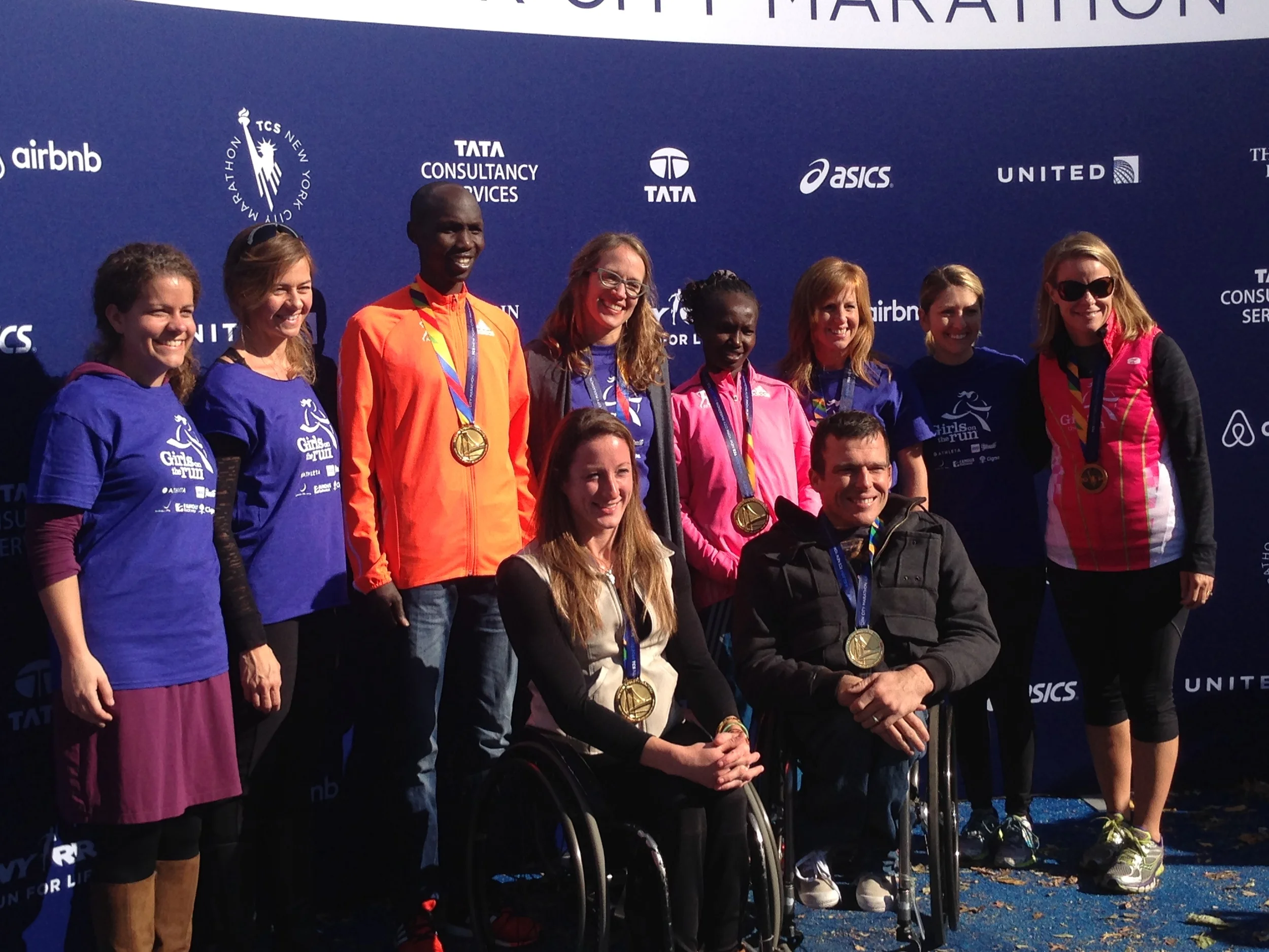 Girls on the Run NYC celebrates with the 2014 NYC Marathon Winners and our very own winner, SoleMate Katherine Slingluff - the one millionth finisher! Seen here: Allison Hauser, Executive Director GIrls on the Run NYC; Stacy Lockhart, Coach; Wilson Kipsang, 2014 Men's NYC Marathon Winner, Katherine Slingluff, Millionth Finisher & Girls on the Run NYC SoleMate; Mary Keitany, 2014 Women's NYC Marathon Winner; Lara Mish, Girls on the Run Chesapeake Council Director; Gloria Mullervey, Girls on the Run NYC SoleMate; Tatyana McFadden, 2014 Women's NYC Marathon Wheelchair Division Winner; Kurt Fearnley, 2014 Men's NYC Marathon Wheelchair Division Winner