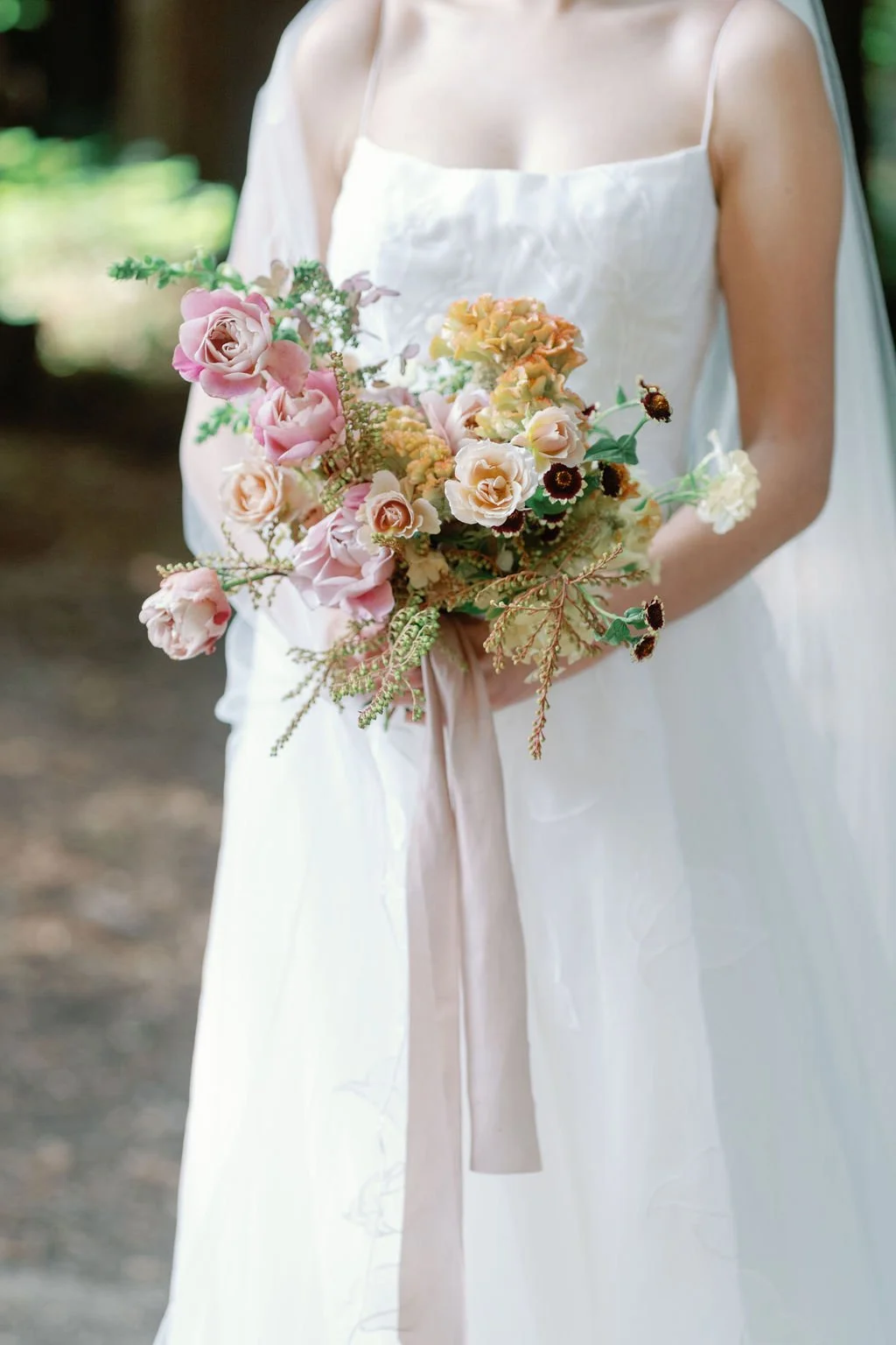 Bride holding pastel garden-style bouquet during Mountain Terrace wedding in Woodside.