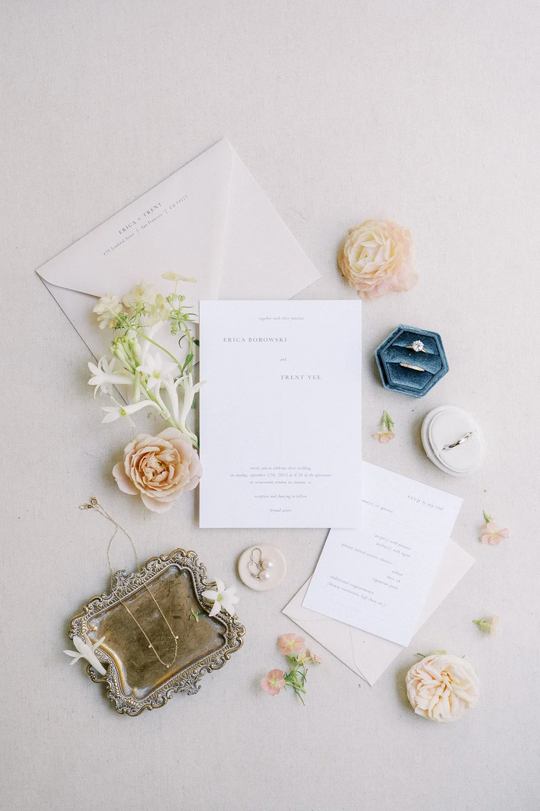 Elegant wedding invitation flatlay with soft florals and heirloom details styled for a Cornerstone Gardens wedding.