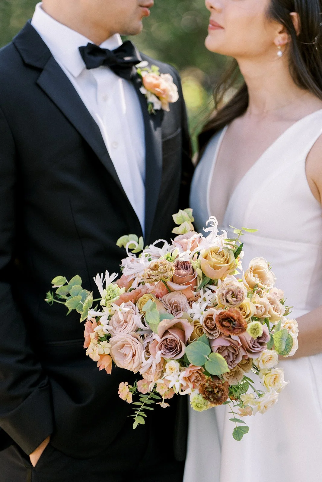 Bride and groom portrait at Cornerstone Gardens wedding with soft blush and neutral floral bouquet.
