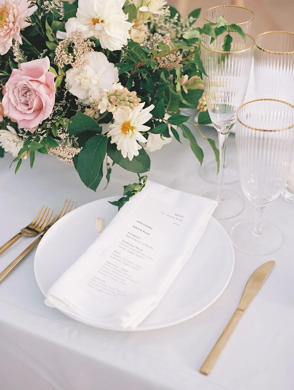 Elegant wedding table setting with florals and place settings at Dos Pueblos Orchid Farm reception.