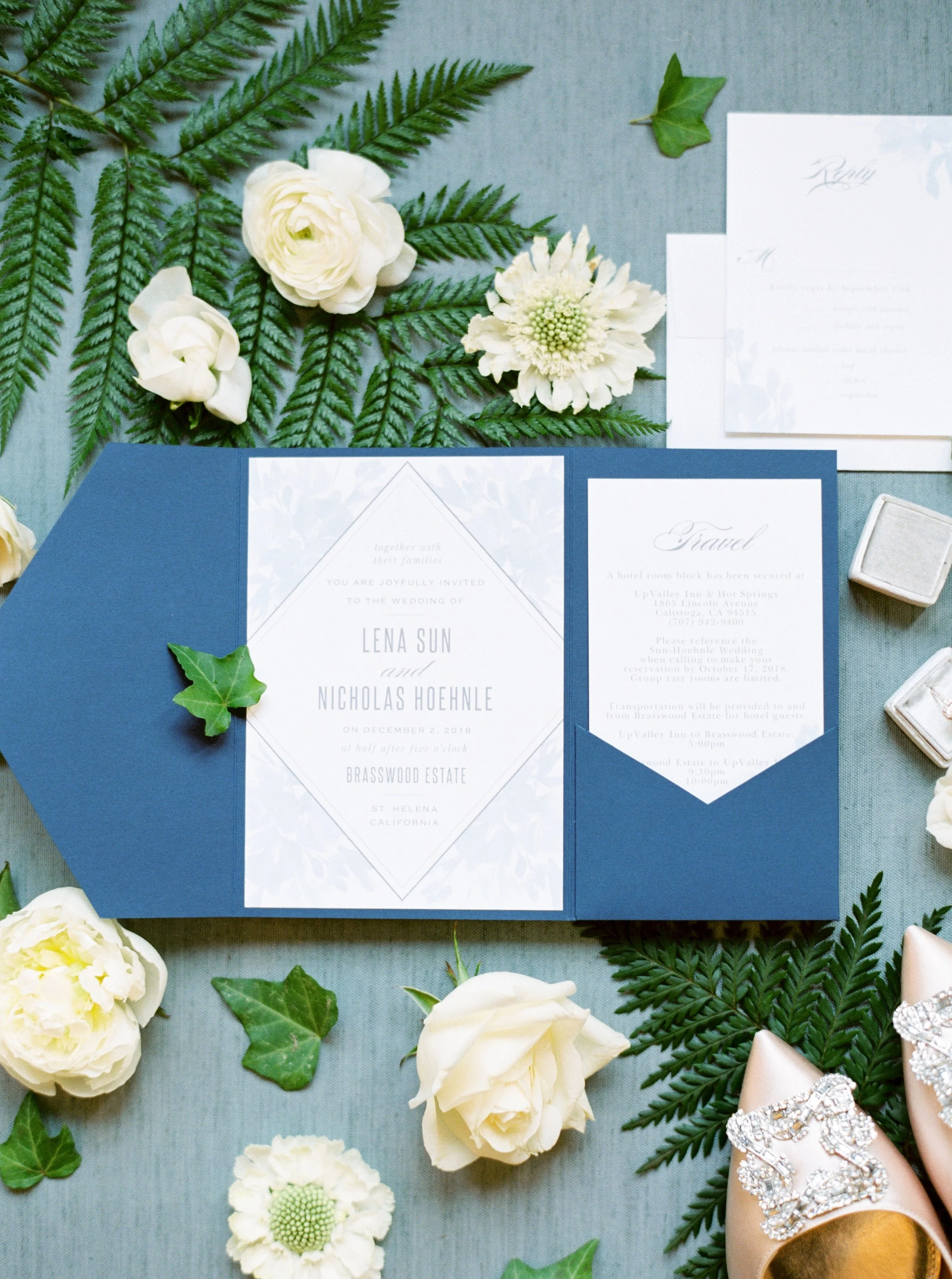Elegant blue and white wedding invitation suite styled with florals and greenery at Brasswood Estate in Napa Valley.