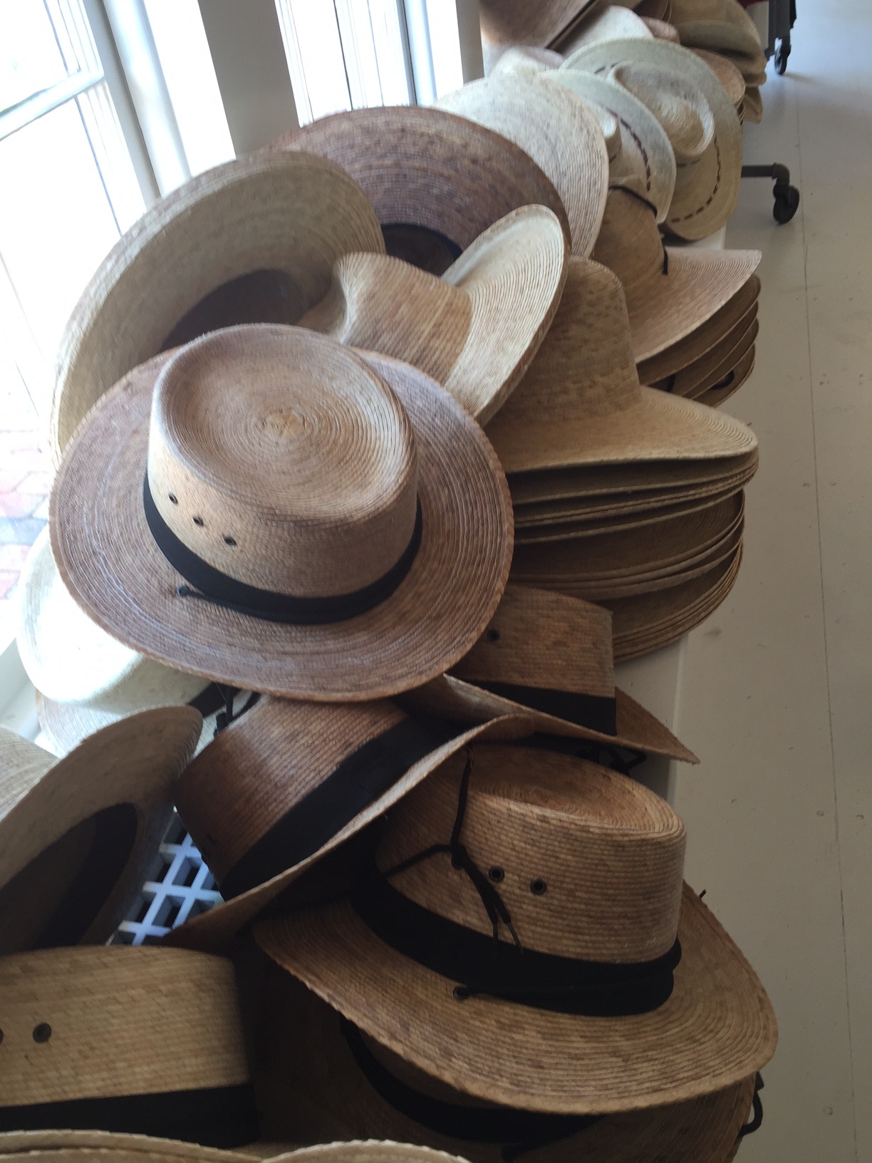  COMMUNITIE _east is the sister store to the first store located in Marfa, Texas. After more than 30 years in the NYC fashion scene, John Patrick moved to Marfa, Texas, to create classic accessories meant to last a lifetime. Hats designed by John Patrick are handwoven from sustainable palm leaves by skilled artisans in Mexico, where many wide-brimmed hats tie under the chin to keep beach breezes at bay. 