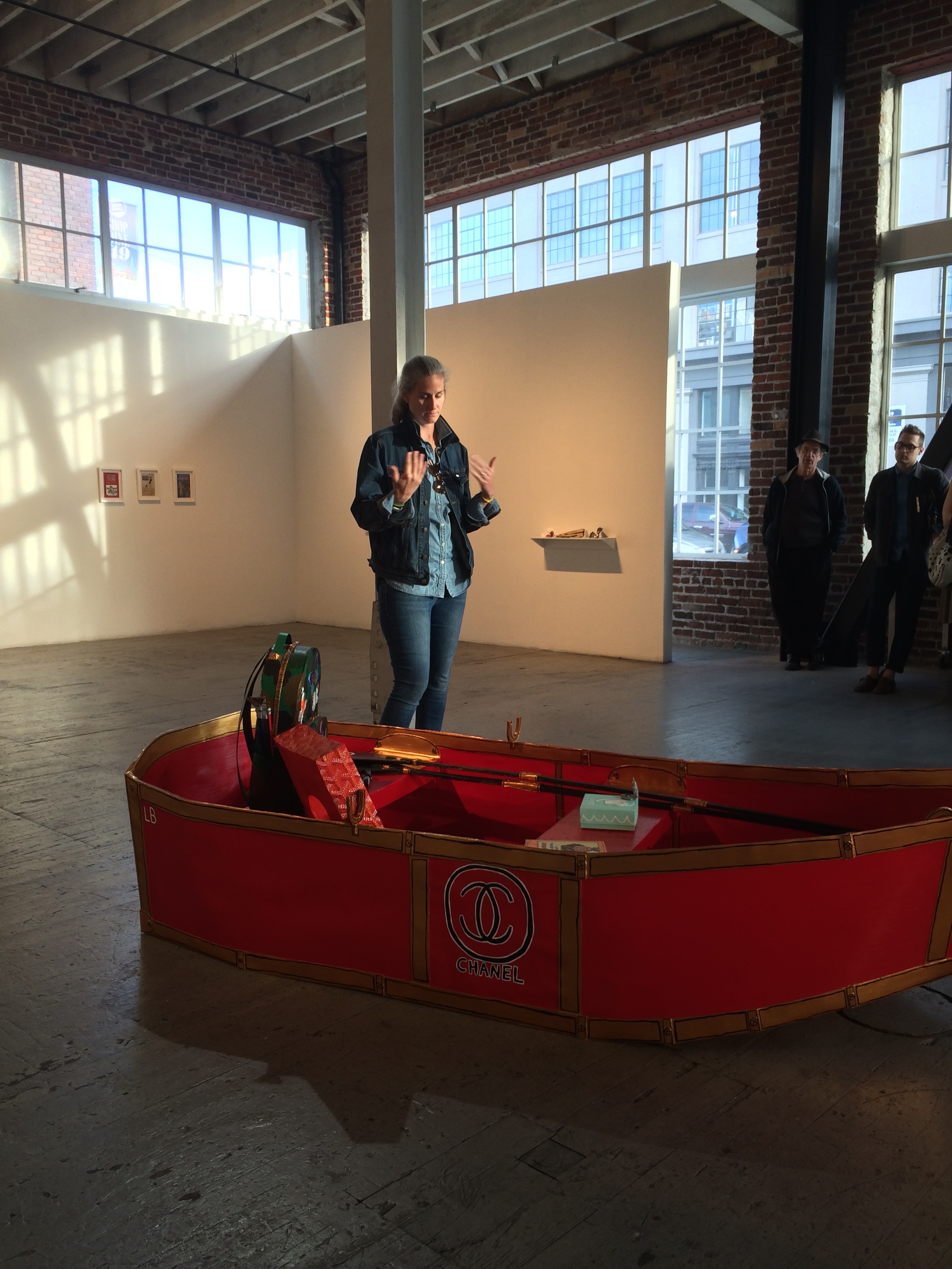 Artist Libby Black stands in front of one of her paper sculptures during her presentation at Gallery 16. -June 2016