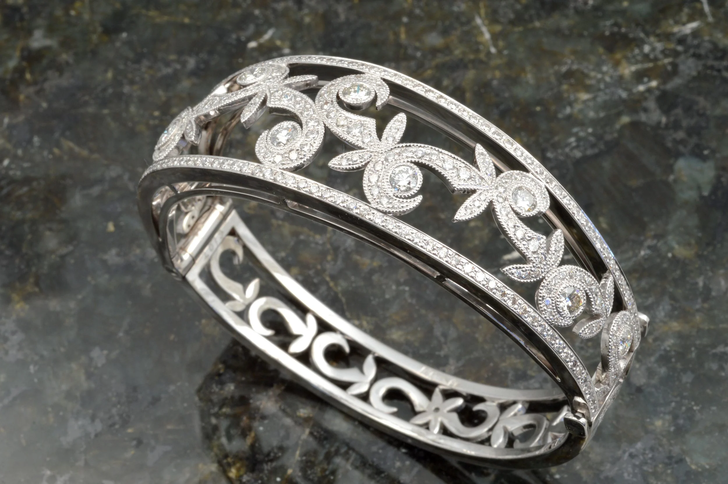 custom designed bangle bracelet set with fine diamonds in a swirl and leaf pattern, designed by Jason Baskin.