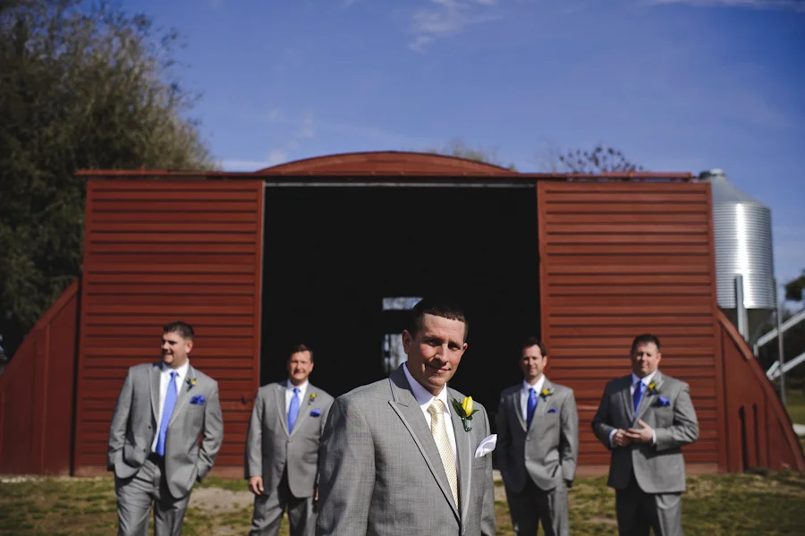 groomsmen in front of a barn