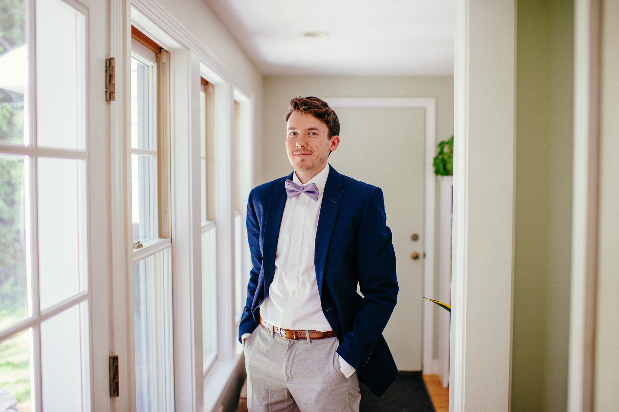  wedding groom blue jacket, grey slacks, purple bow tie 
