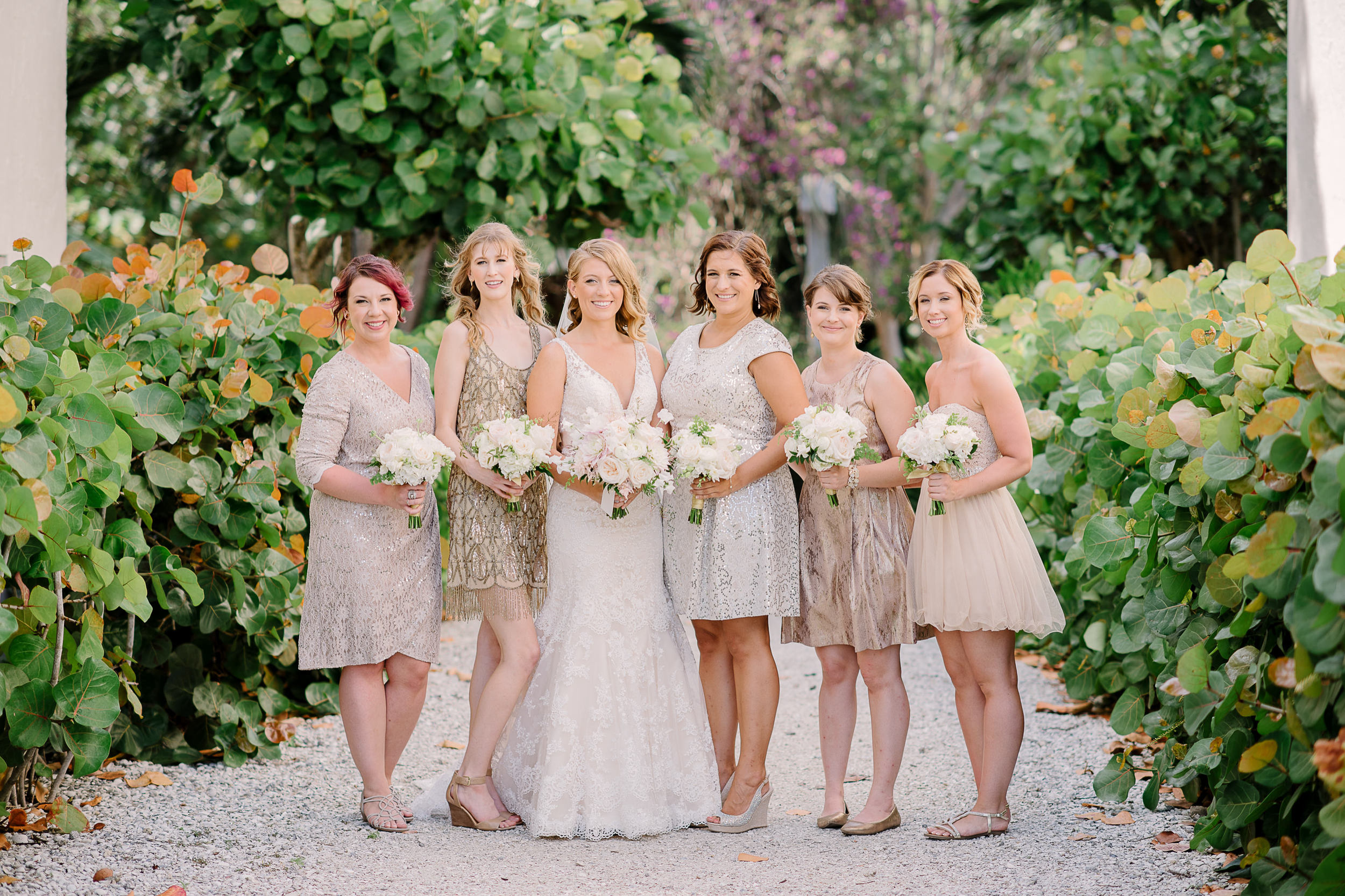 short mismatched gold, silver, and champagne bridesmaids dresses