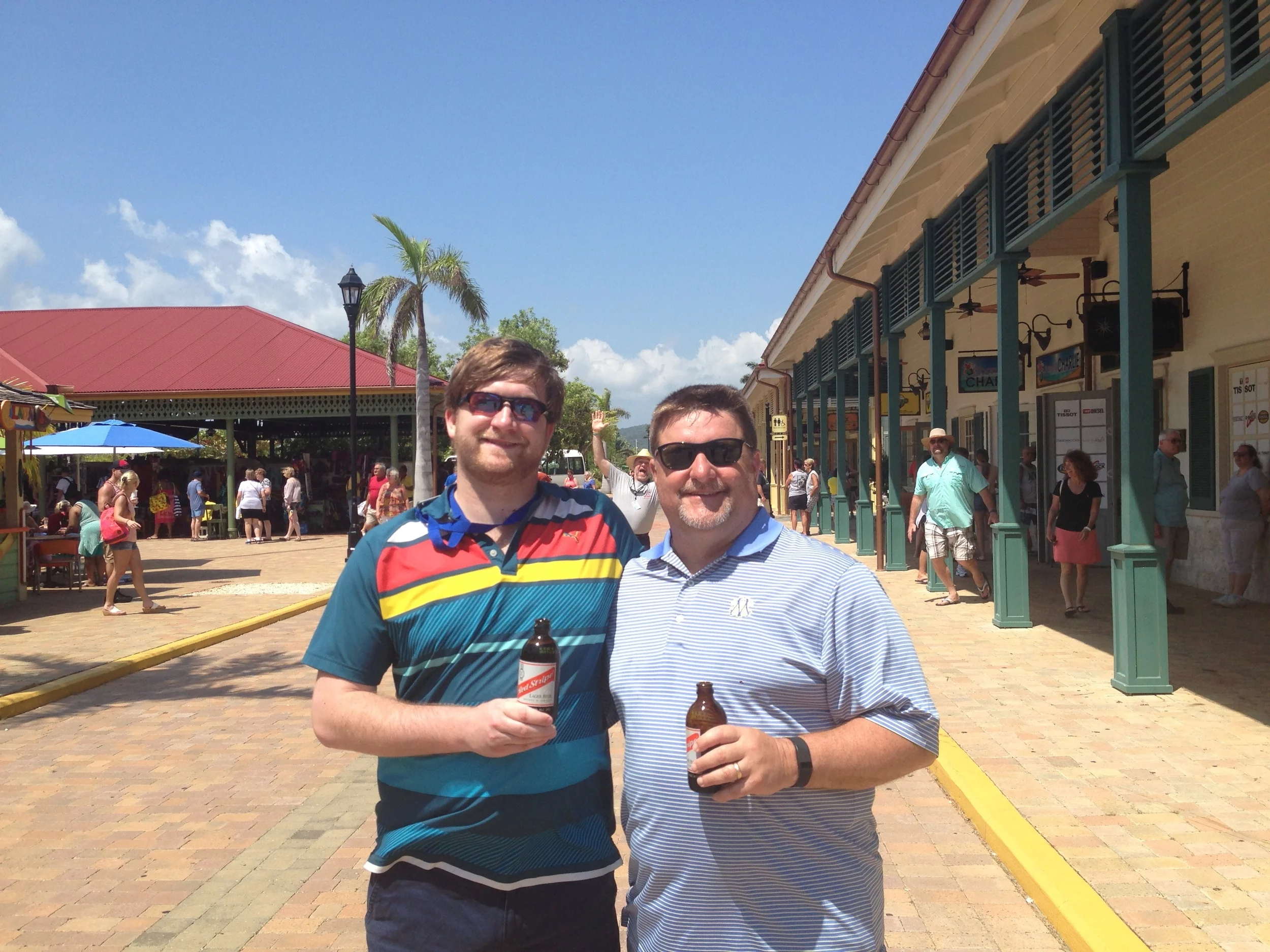 Josh and his dad being photobombed by others from the cruise crew.