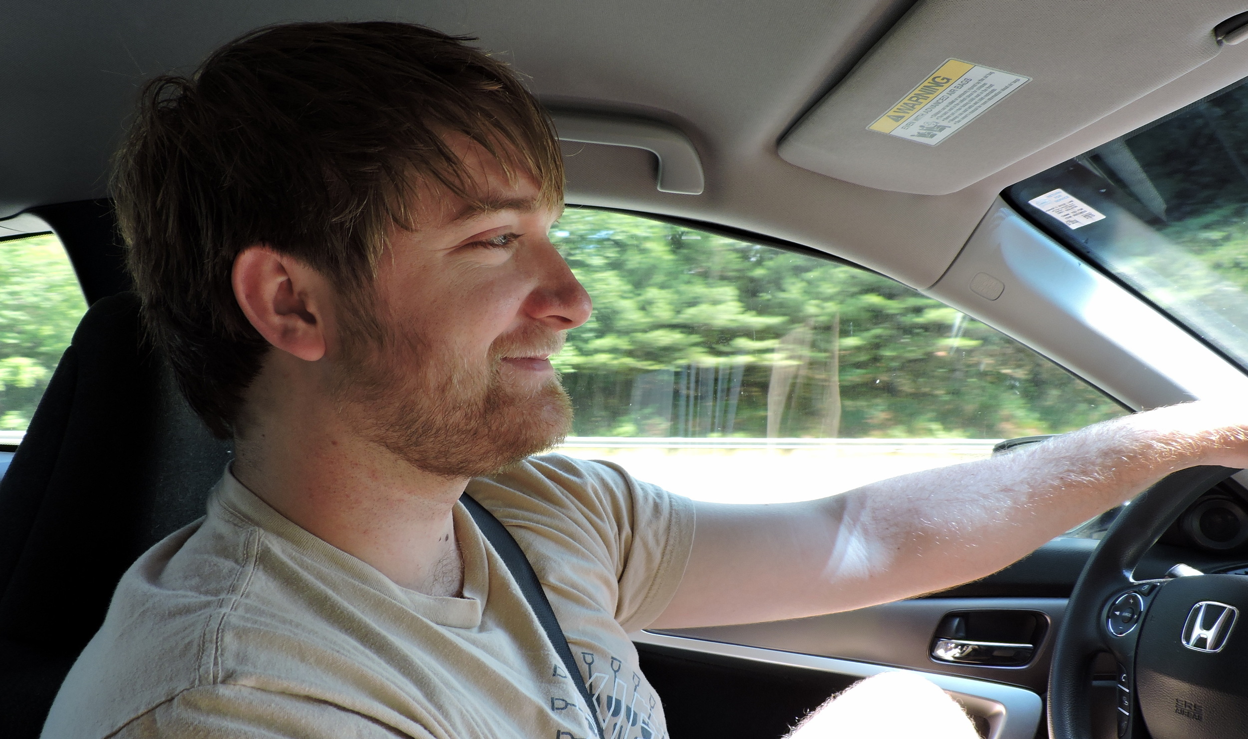 Josh drapes his arm casually over the steering wheel as he heads towards our first destination--Lonesome Lake.