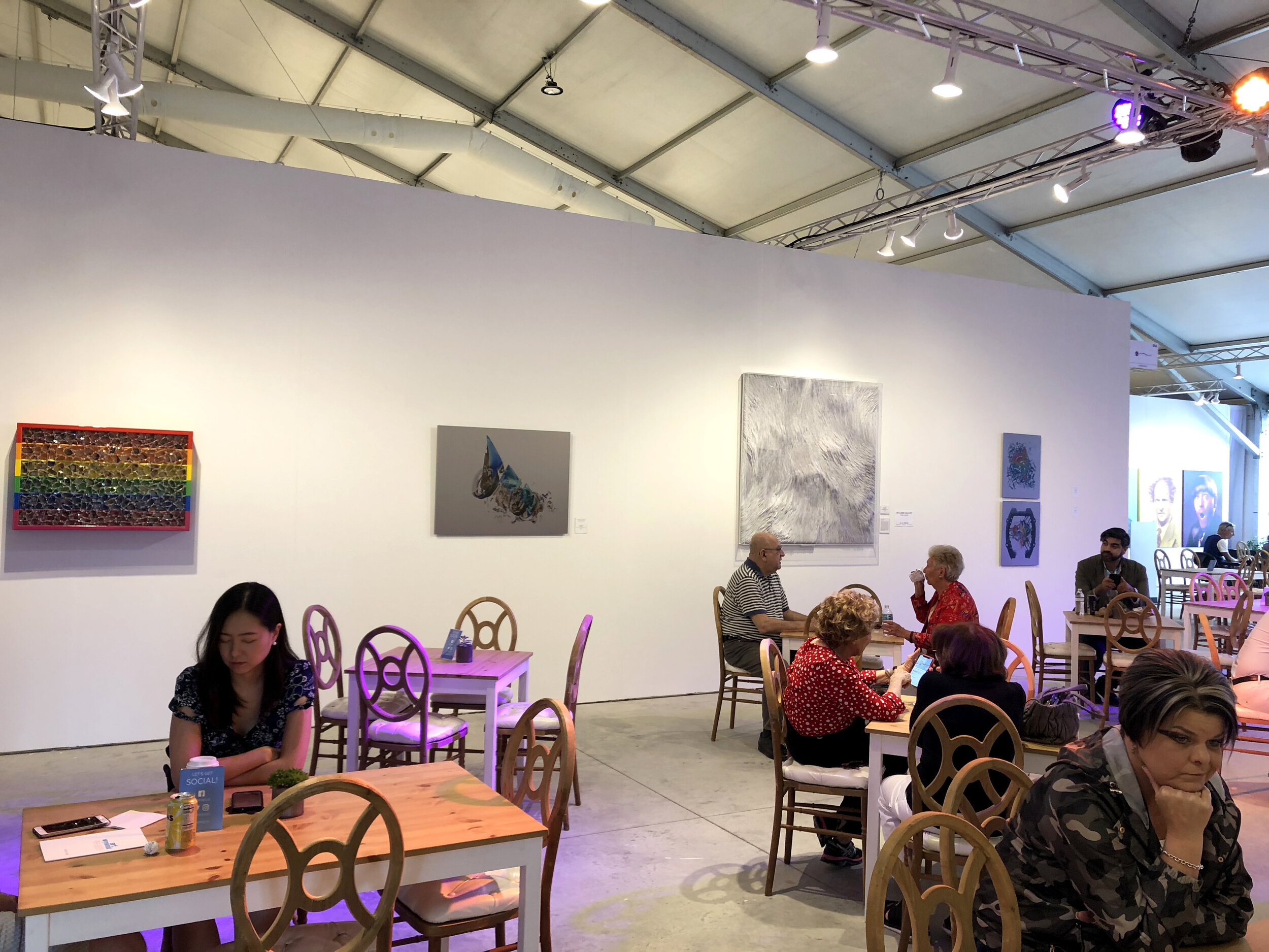 Santiago Medina's "Time and Space", laser image on Italian stainless steel, centrally featured in the public café space at Art Wynwood 2020. Medina's work is the second from the left. 