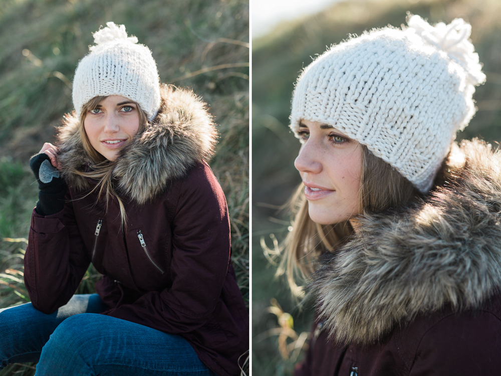 White handknit winter hat with pom pom on model in south portland, maine