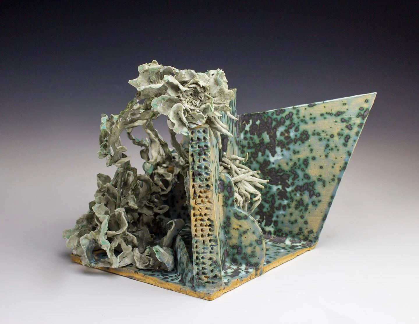 Hiraeth| Colored porcelain and stoneware with glaze | 13.5" x 13.75" x 9"|2022 The Welsh word hiraeth describes a deeply felt connection to one&rsquo;s homeland and casts its wood and hills in an almost magical glow.
It is rather a yea