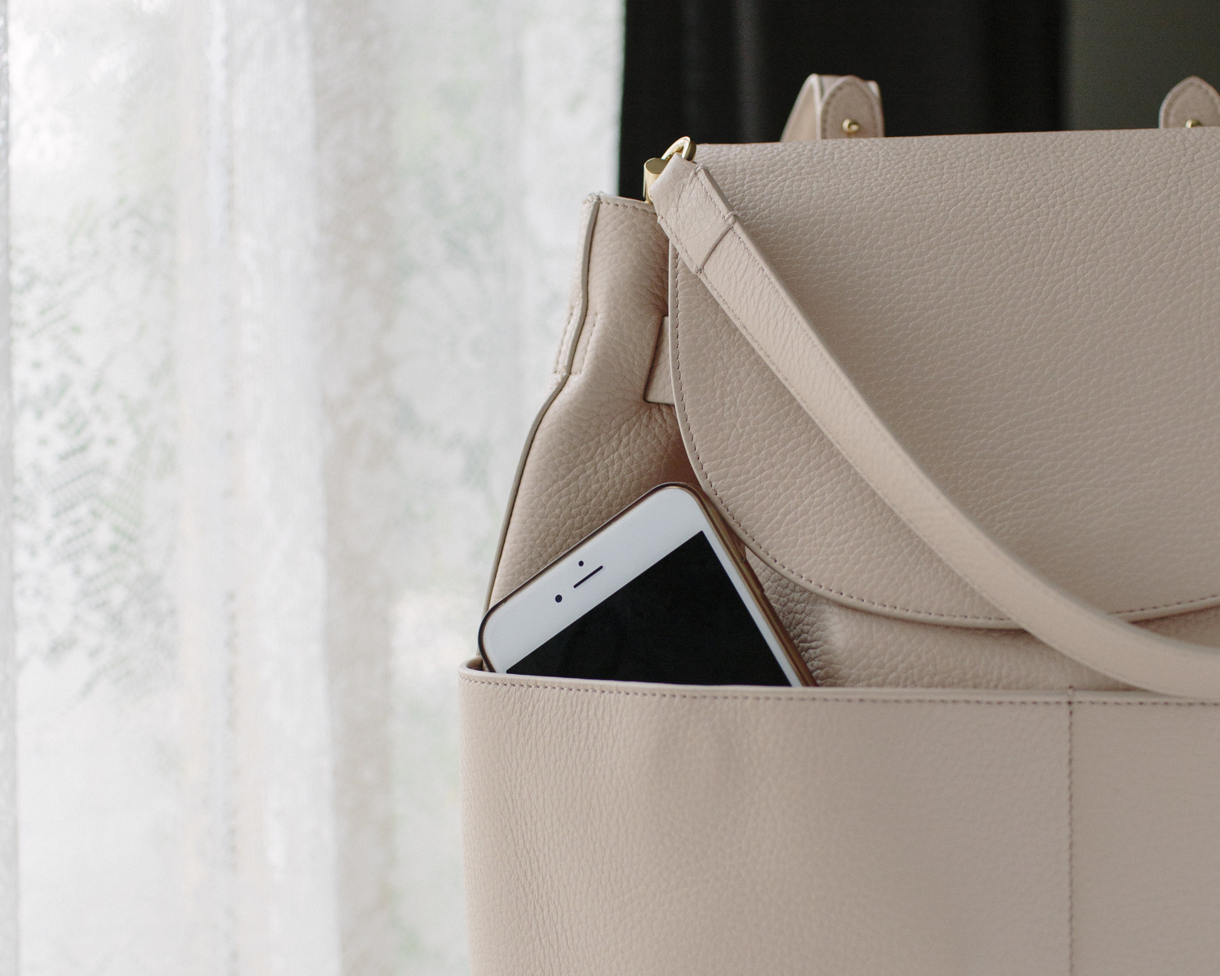 Front pockets and a strap that you can clasp on if you'd prefer to carry the backpack like a tote bag.