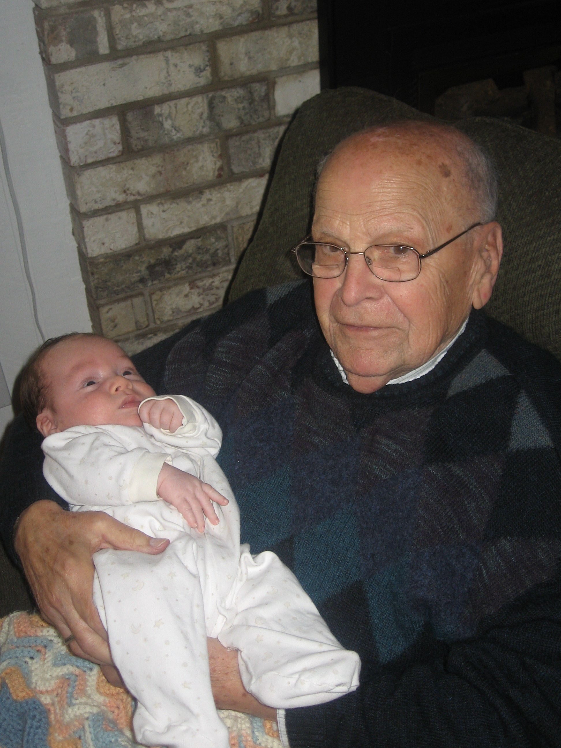 My grandpa holding my nephew, his youngest son's first grandchild.