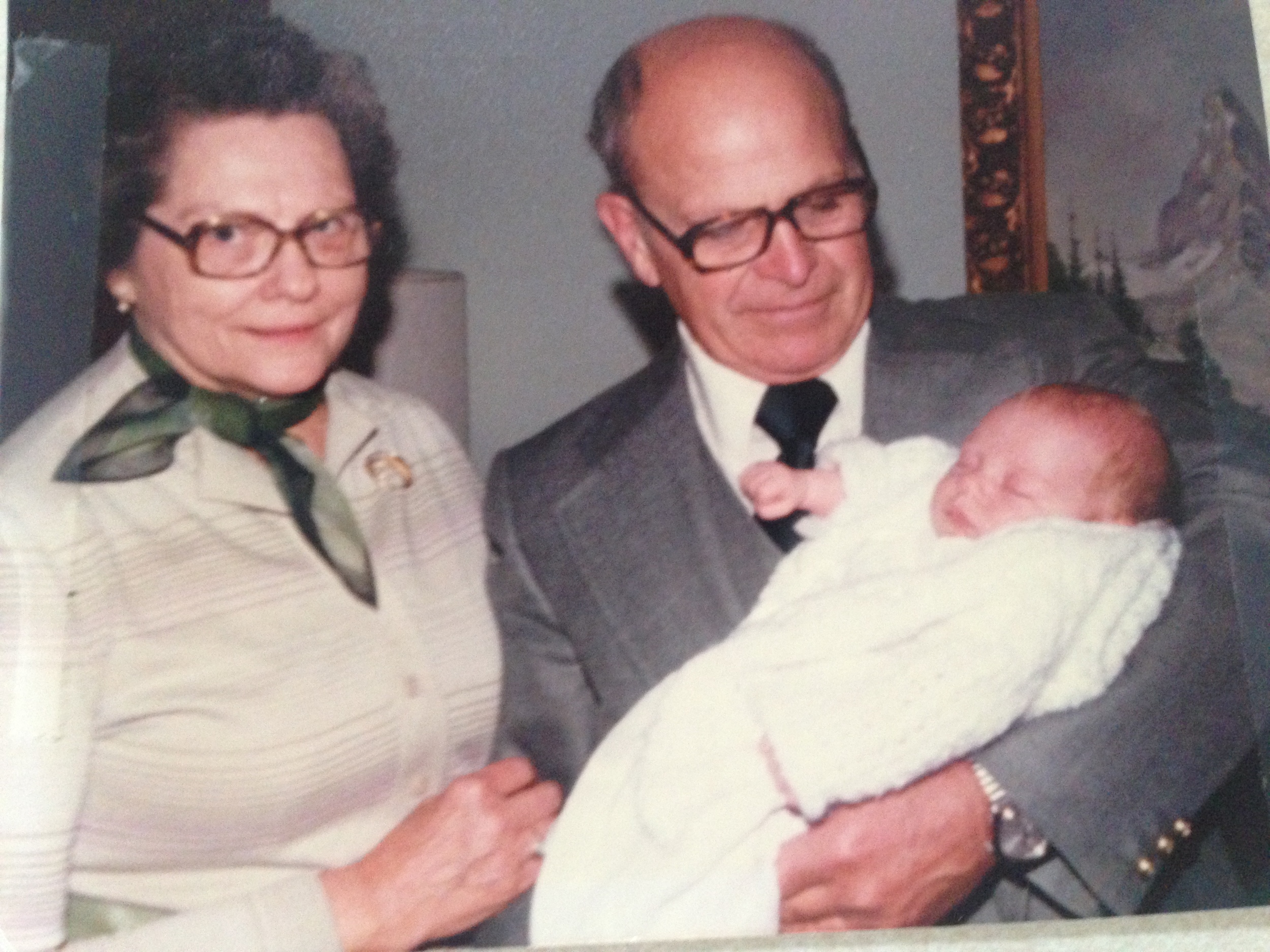My grandpa holding me with my grandma looking on.