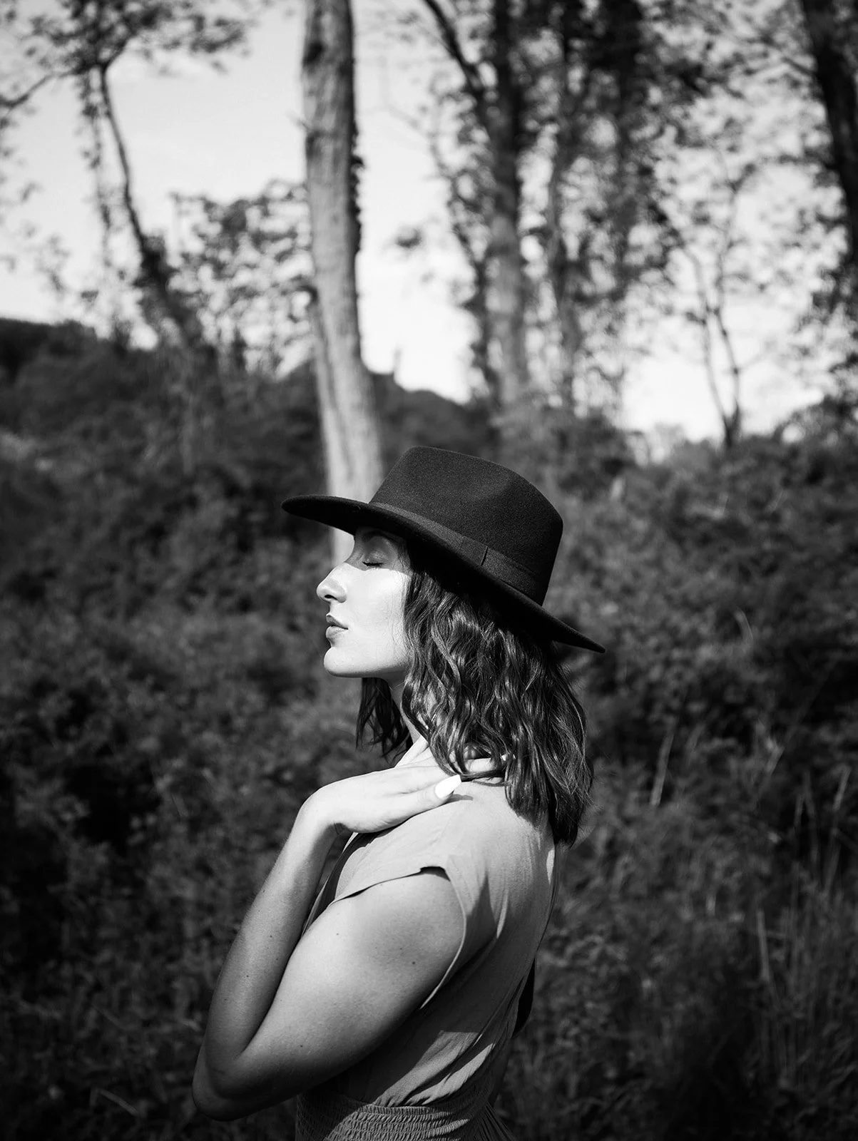 Black and white side portrait in a wide brim hat