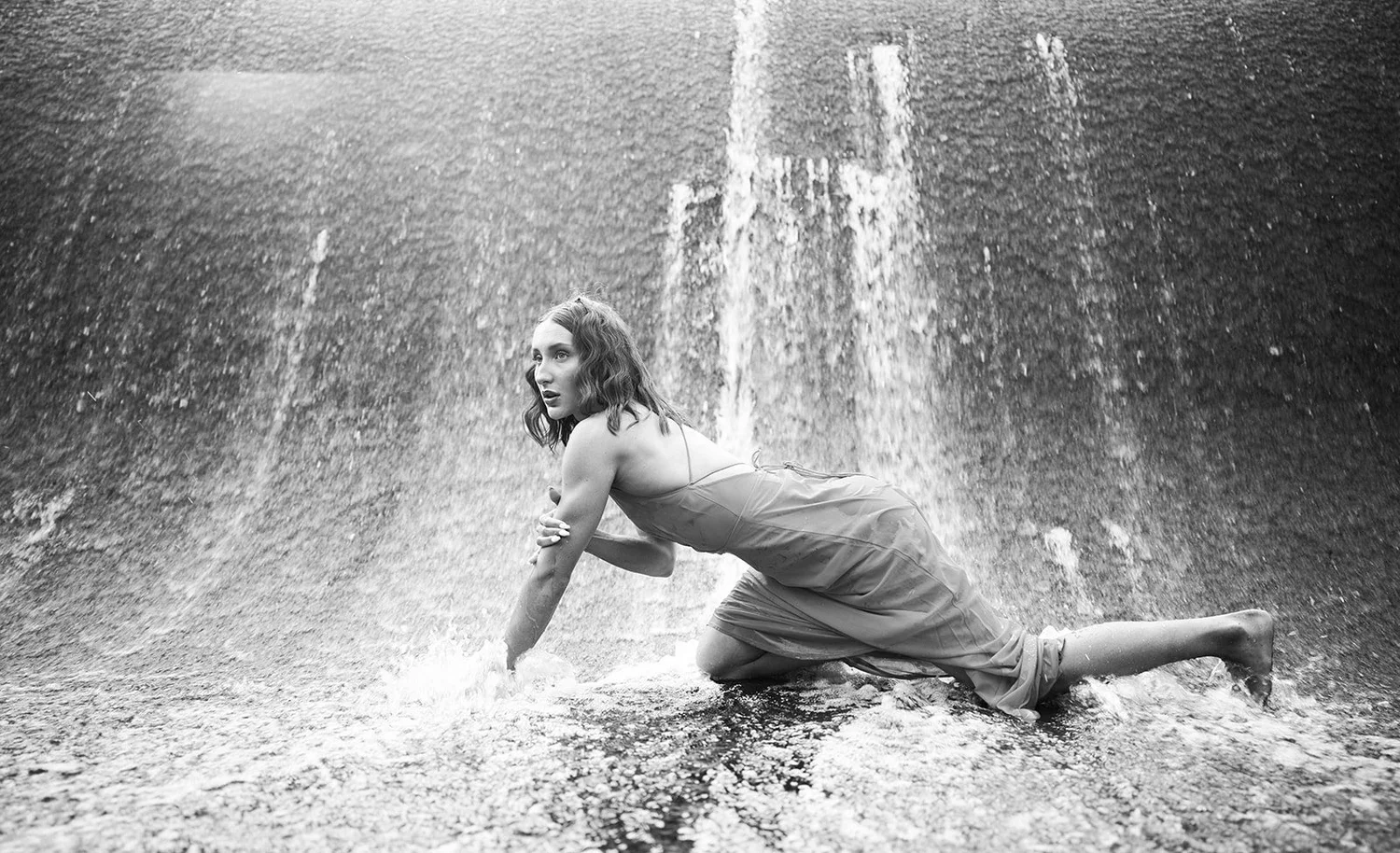 Black and white portrait moving through falling water