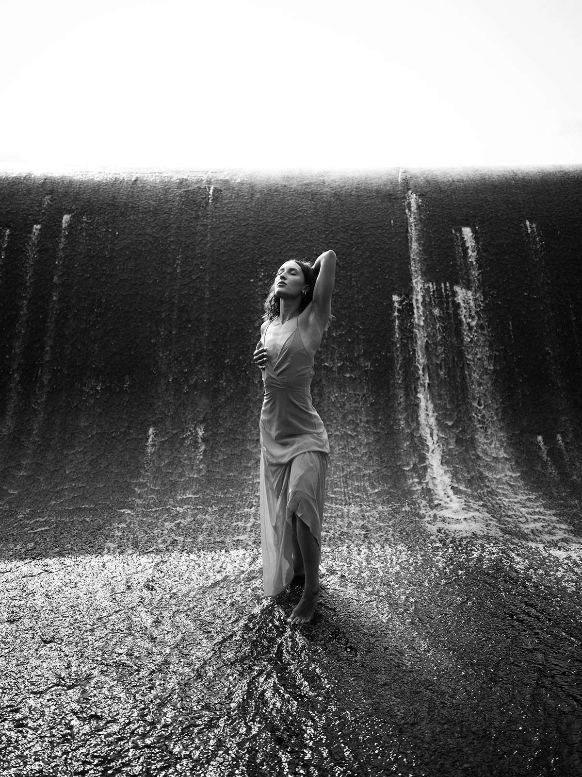Black and white full-length portrait in falling water