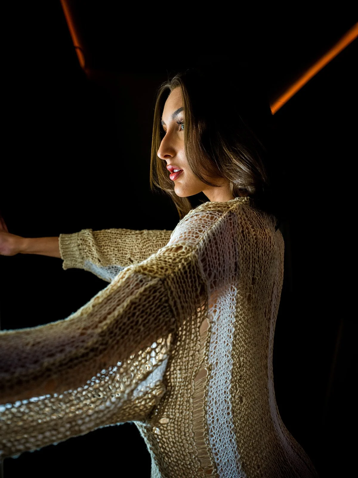 Side portrait in dramatic dark window light