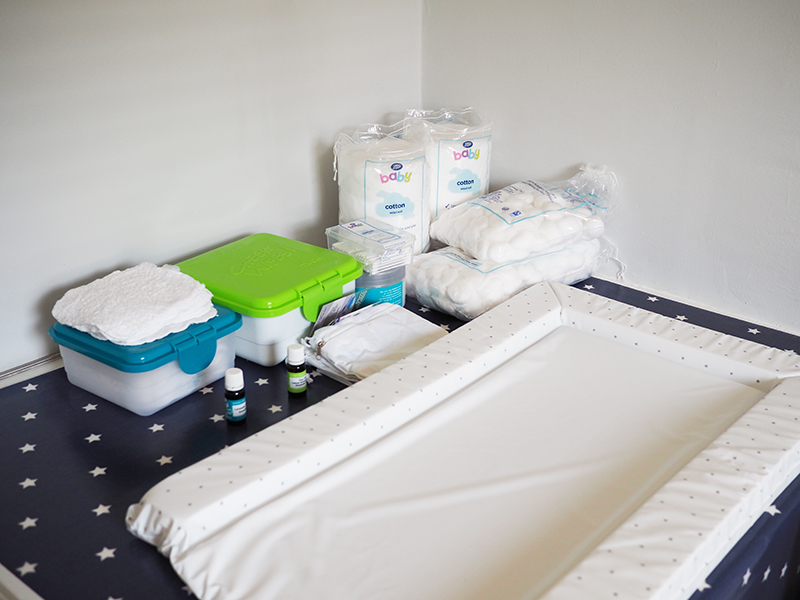 In this room there is a weird sort of solid block that covers the stairs - which was always a strange feature in the room, but now it is making the perfect changing station. We decided to get a waterproof tablecloth from the local fabric shop and then just make sure everything was handy and in easy reach.