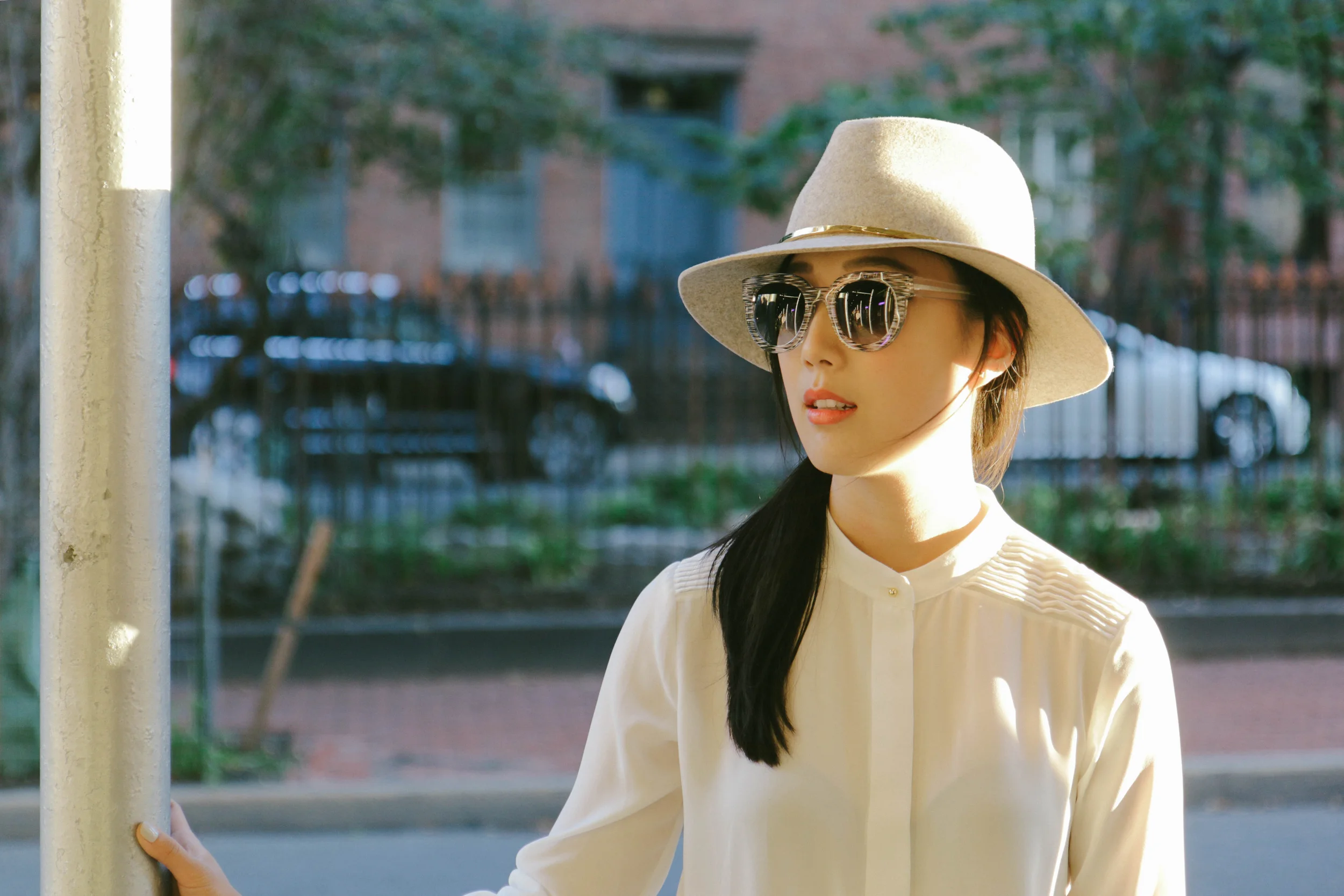 Sam Edelman Pleated Blouse , Asymmetrical Skort , Baseball Jacket , Circus by Sam Edelman Whitley Boots , Céline Trapeze Bag, Thierry Lasry Sunglasses , Janessa Leone Hat