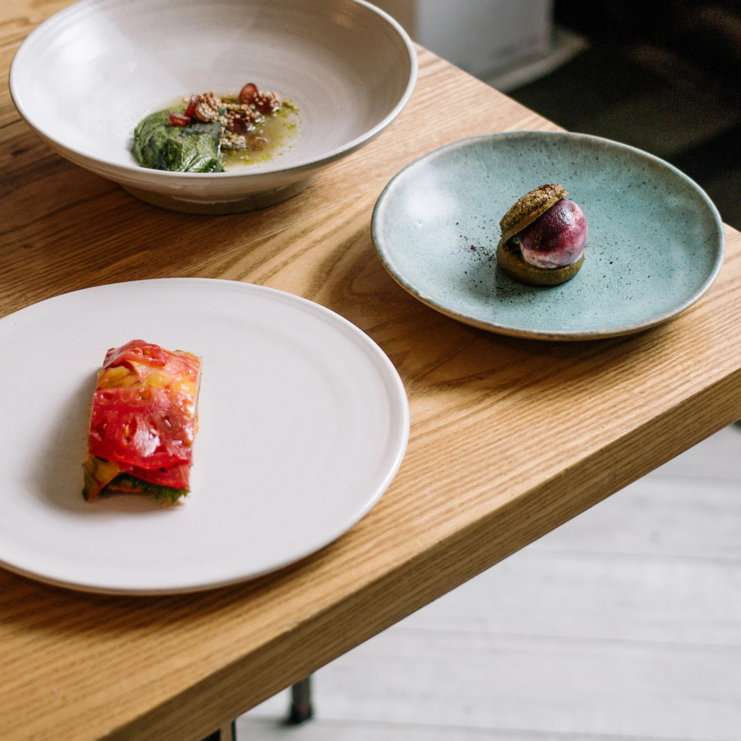 Tomato tart; Roasted eggplant, espelette pepper leafs and champagne grapes; Tarragon profiterole with wild blueberry and buttermilk