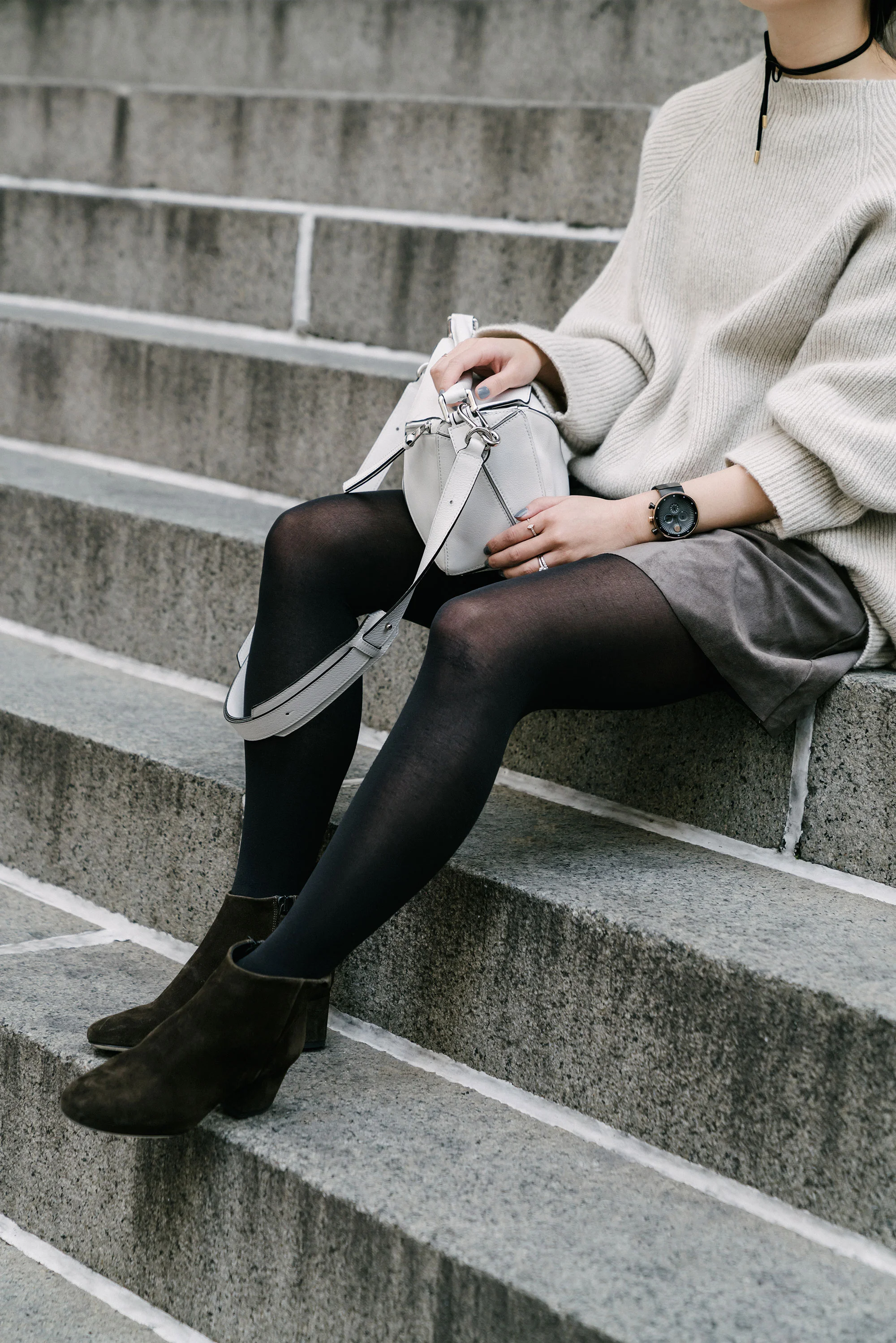 Movado Watch , The Row Sweater, Aritzia Skirt , Yvonne Koné Boots , Loewe Bag , Janessa Leone Hat , Fendi Sunglasses , Kat Kim New York Rings