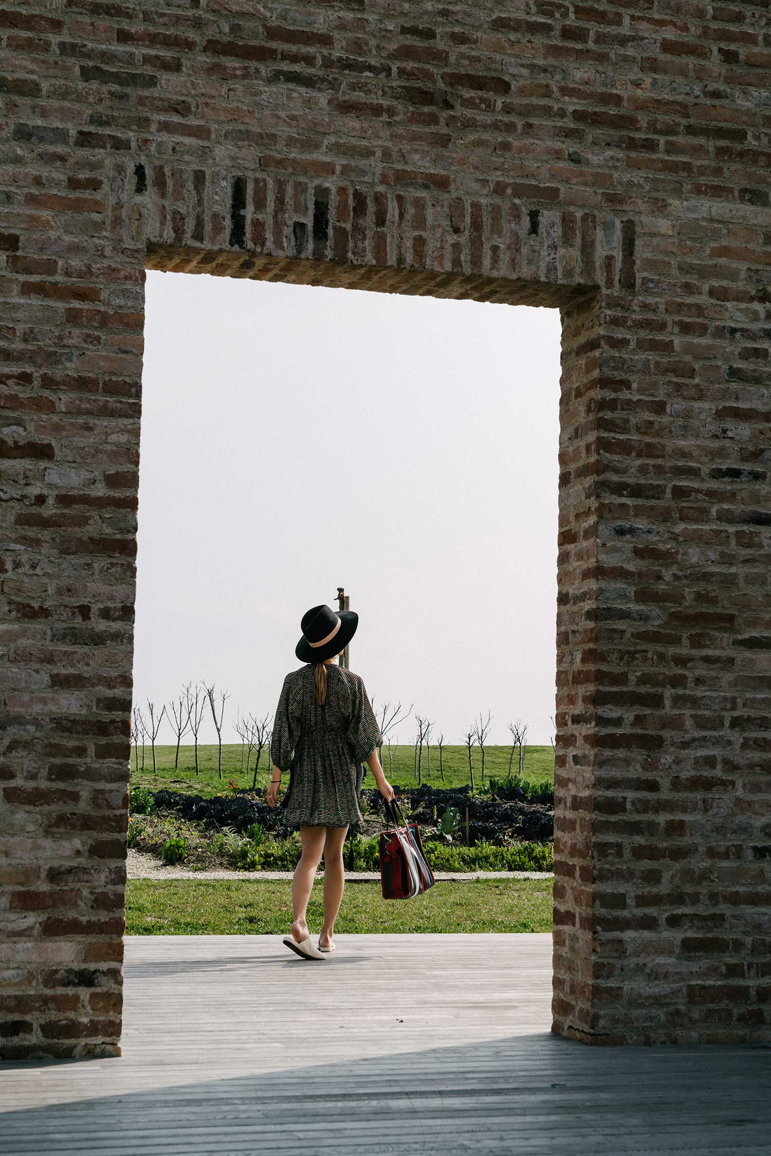 Apiece Apart Dress, Vince Shoes , Balenciaga Bag, Céline Sunglasses, Janessa Leone Hat , Simon Miller x Rebecca Pinto Earrings