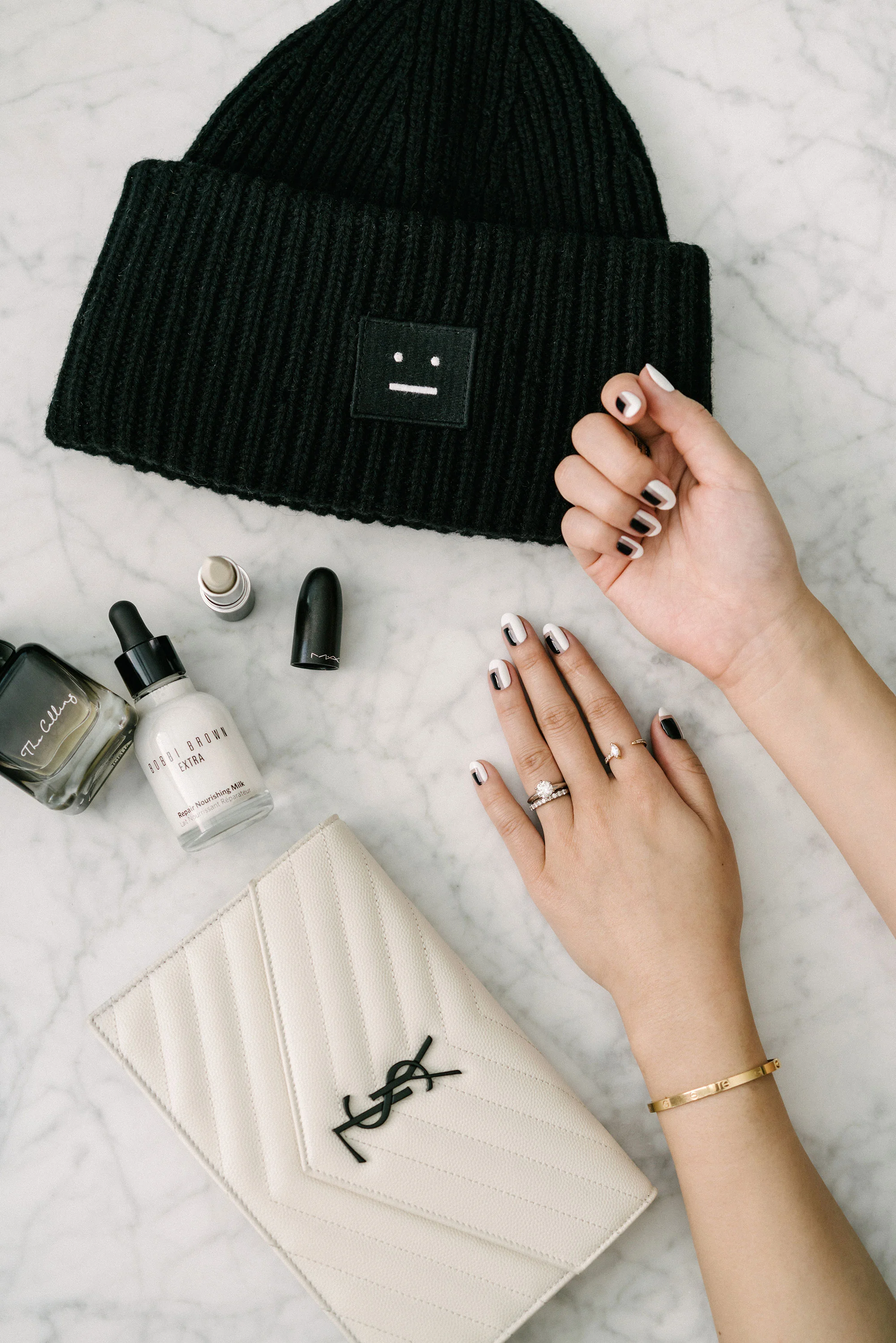 Phuong Dang Perfume , Bobbi Brown Milk , MAC Lipstick , Acne Studios Beanie, Saint Laurent Clutch, Cartier Bracelet , Kat Kim Ring