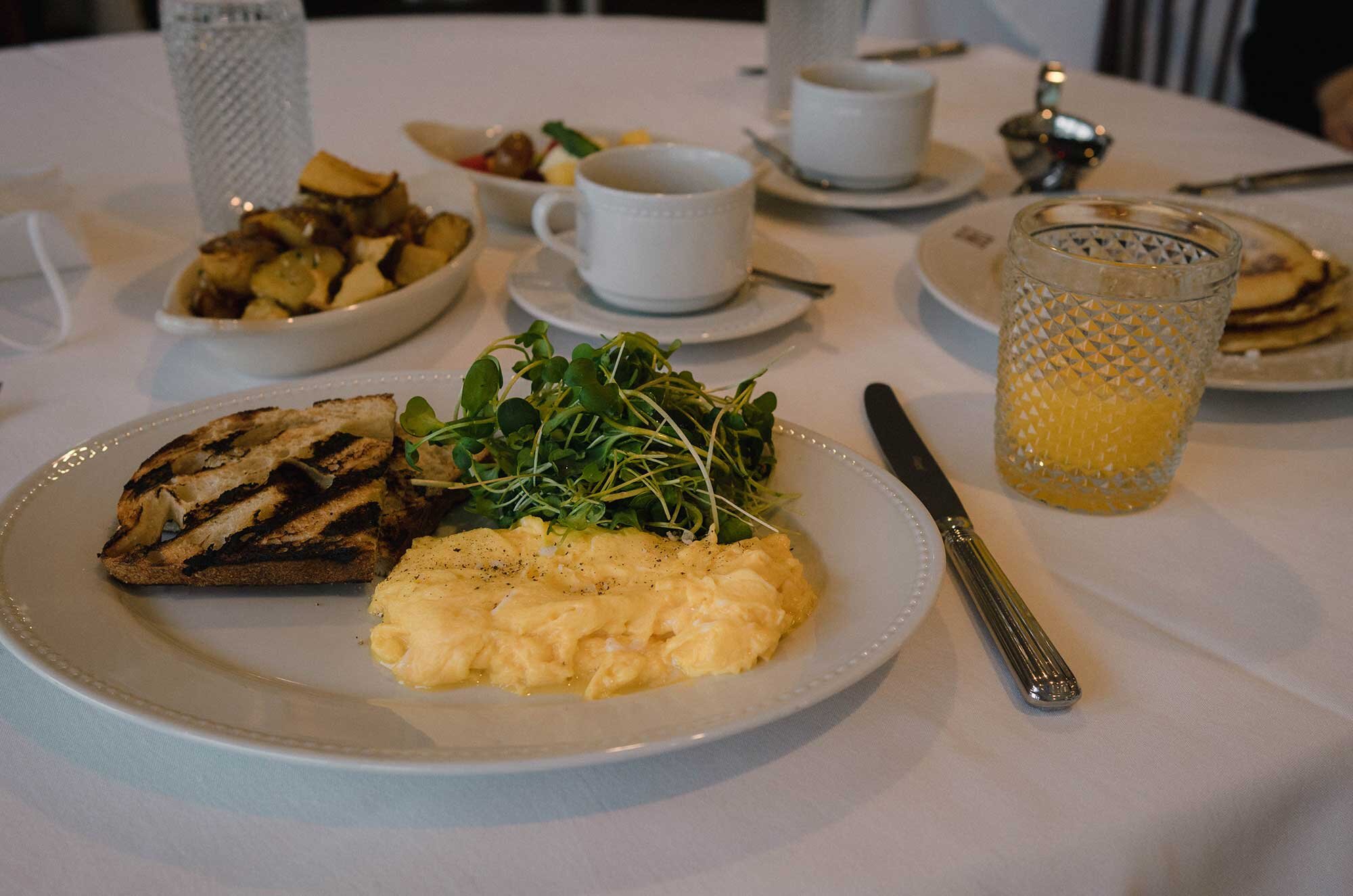 Scrambled Eggs w/ micro-greens salad, grilled toast